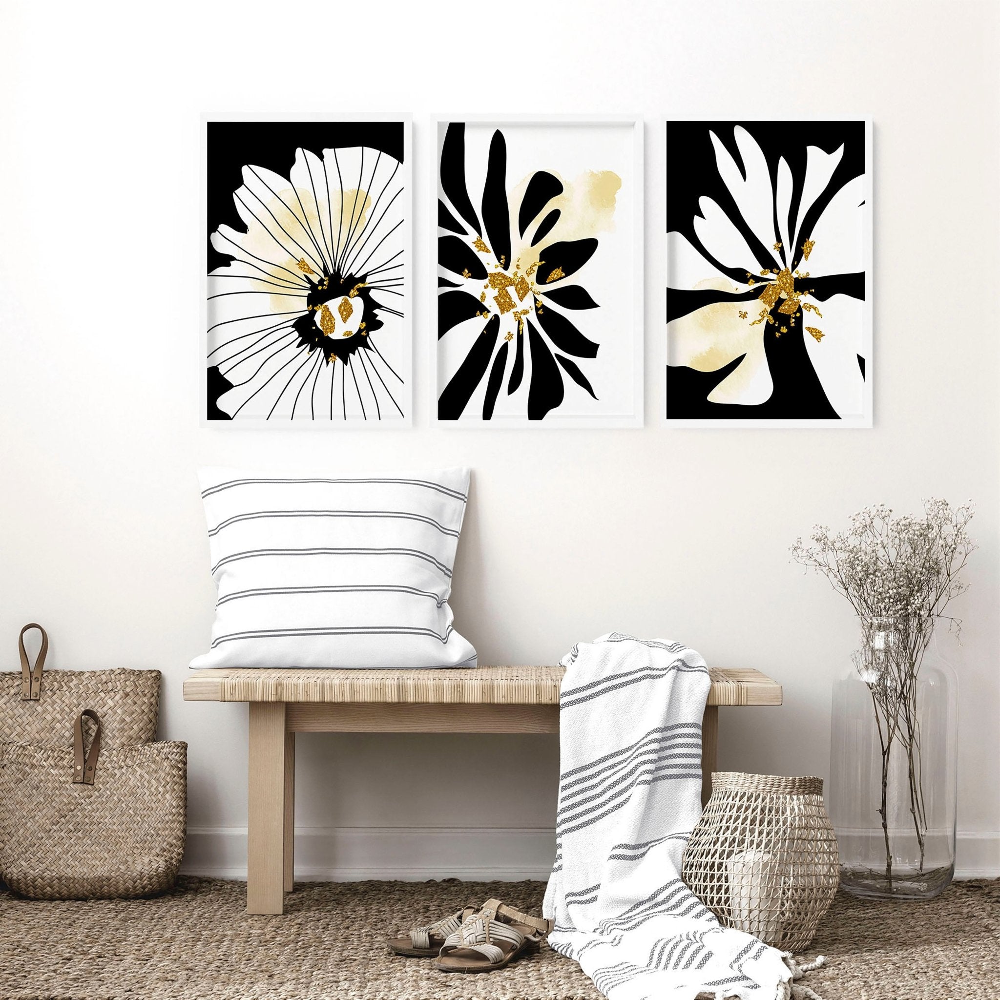 Set of 3 framed black and white botanical prints with gold shimmer details, elegantly displayed on a wall.