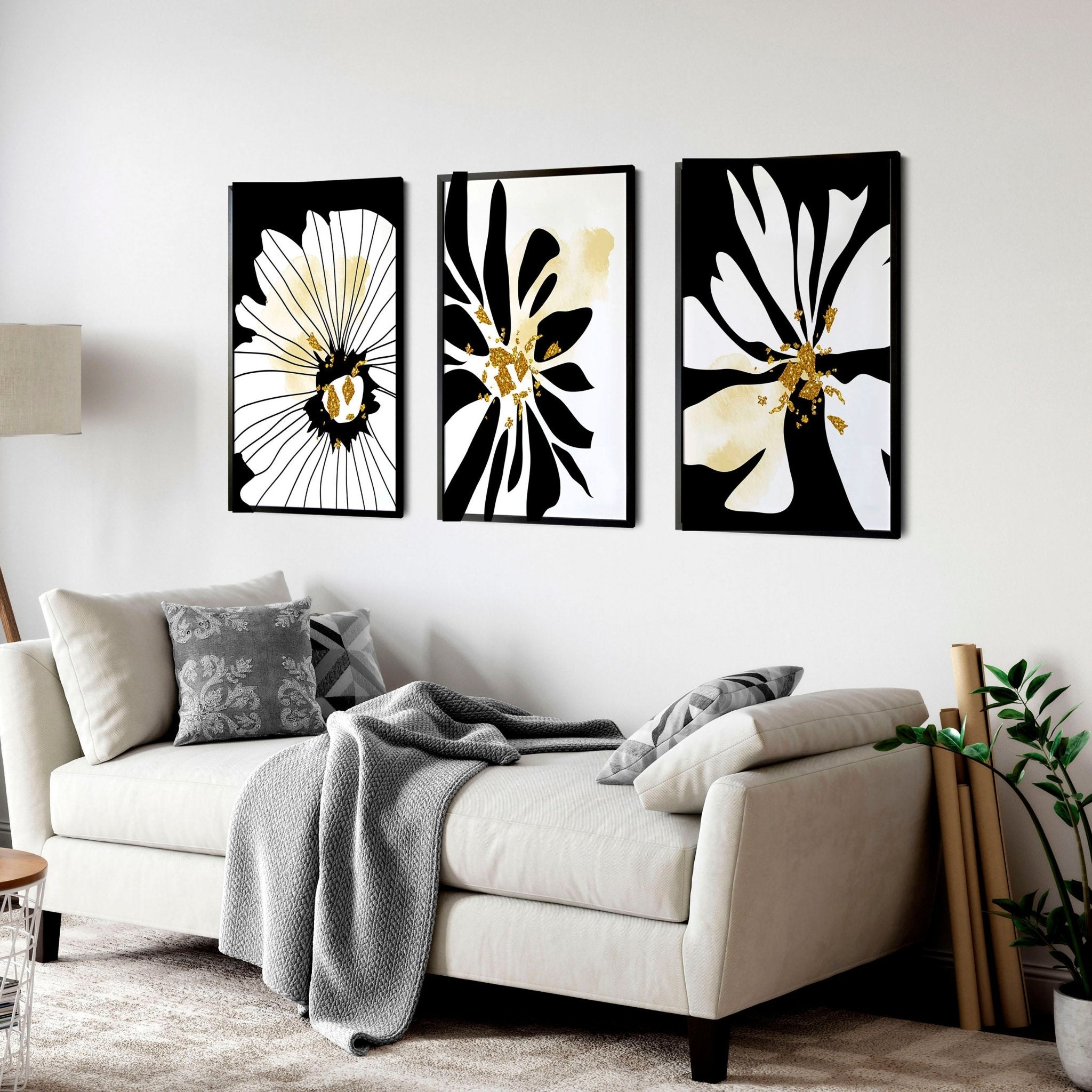 Set of 3 framed black and white botanical prints with gold shimmer details, elegantly displayed on a wall.