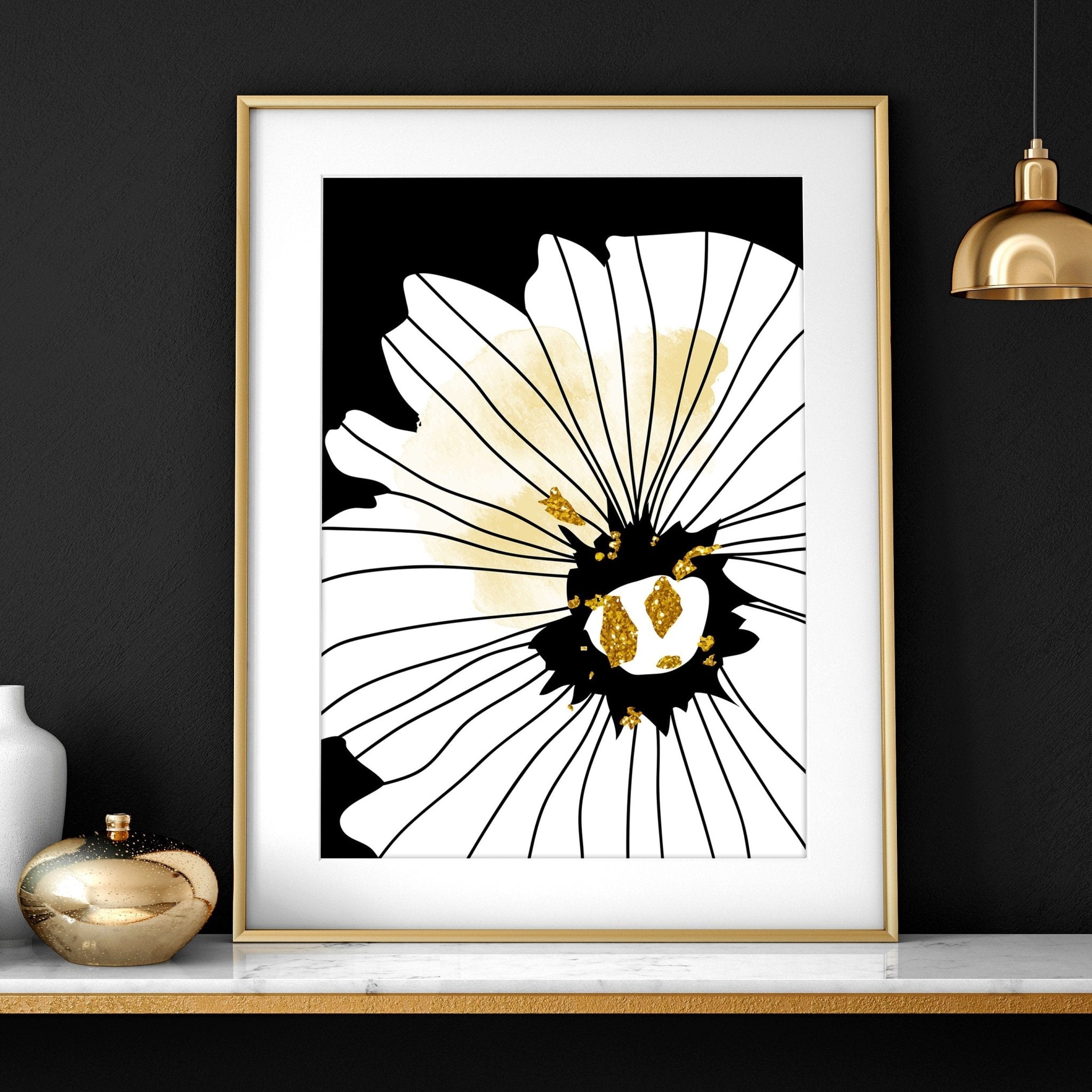 Set of 3 framed black and white botanical prints with gold shimmer details, elegantly displayed on a wall.