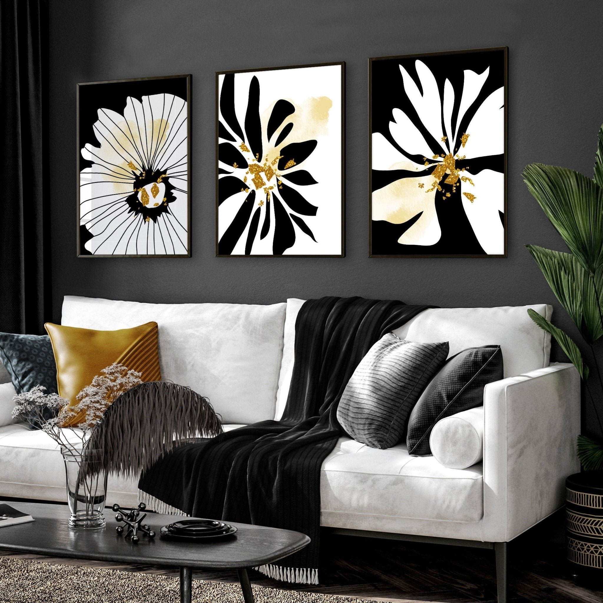 Set of 3 framed black and white botanical prints with gold shimmer details, elegantly displayed on a wall.
