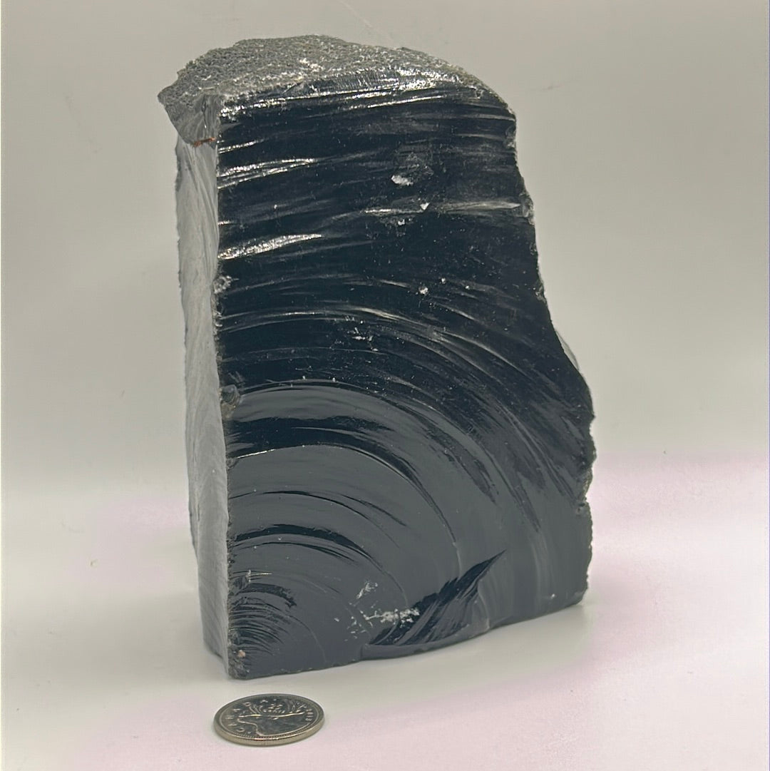 Black Obsidian Rough Cut Freeform, approximately 6 inches by 4 inches, showcasing its natural volcanic glass texture and unique shape.