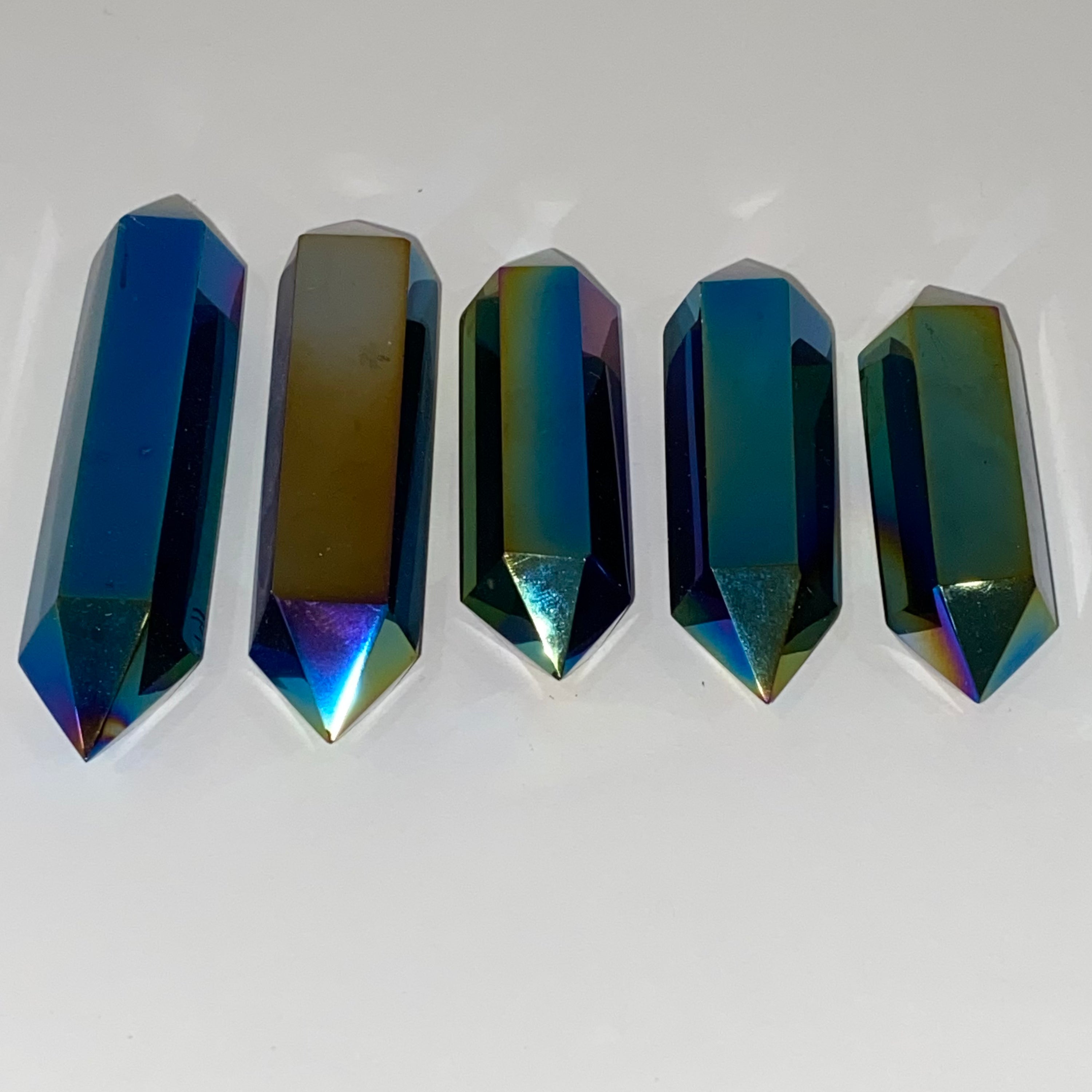 A stunning Black Obsidian Titanium Double Terminated Point with a shiny metallic finish, showcasing its unique double-ended design.