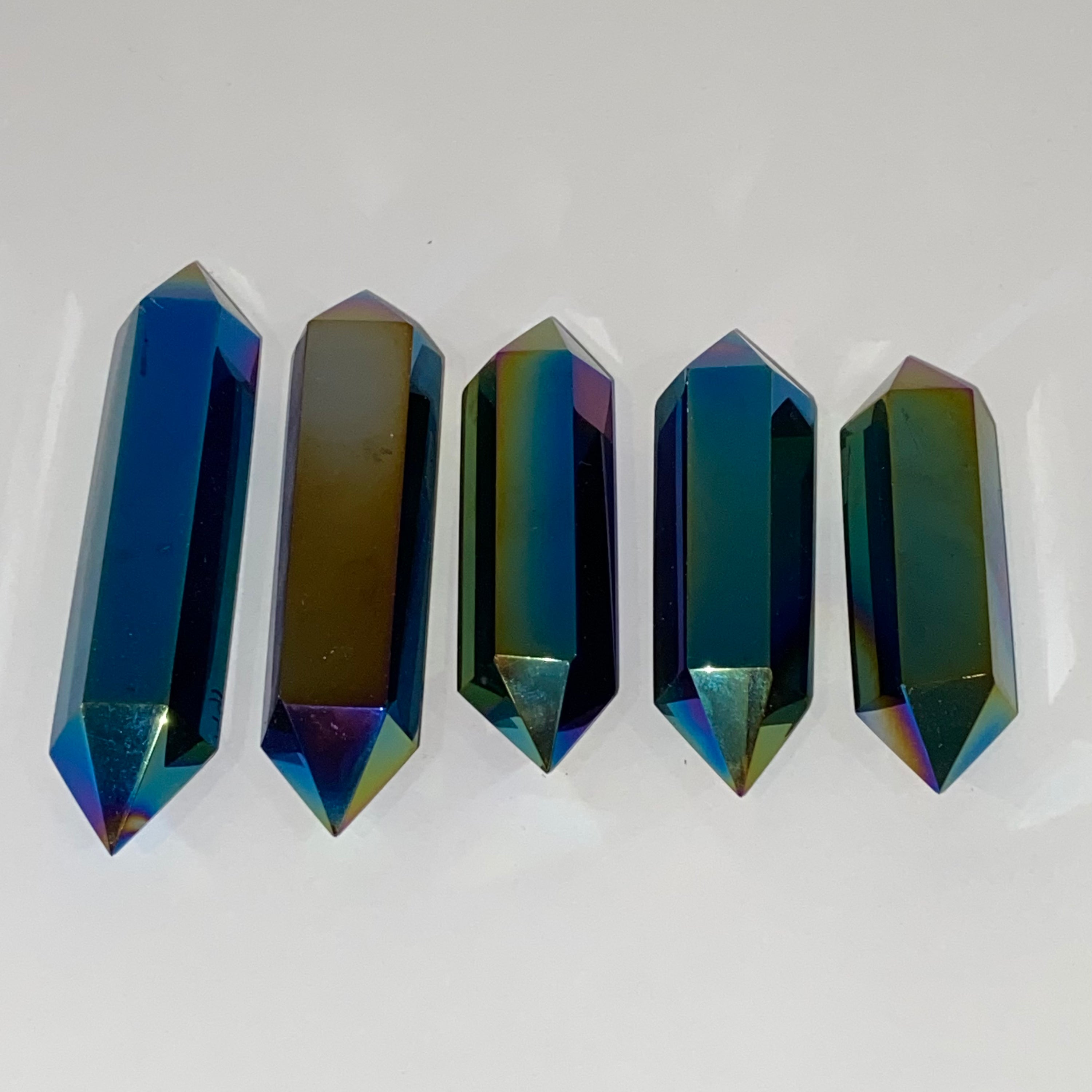 A stunning Black Obsidian Titanium Double Terminated Point with a shiny metallic finish, showcasing its unique double-ended design.