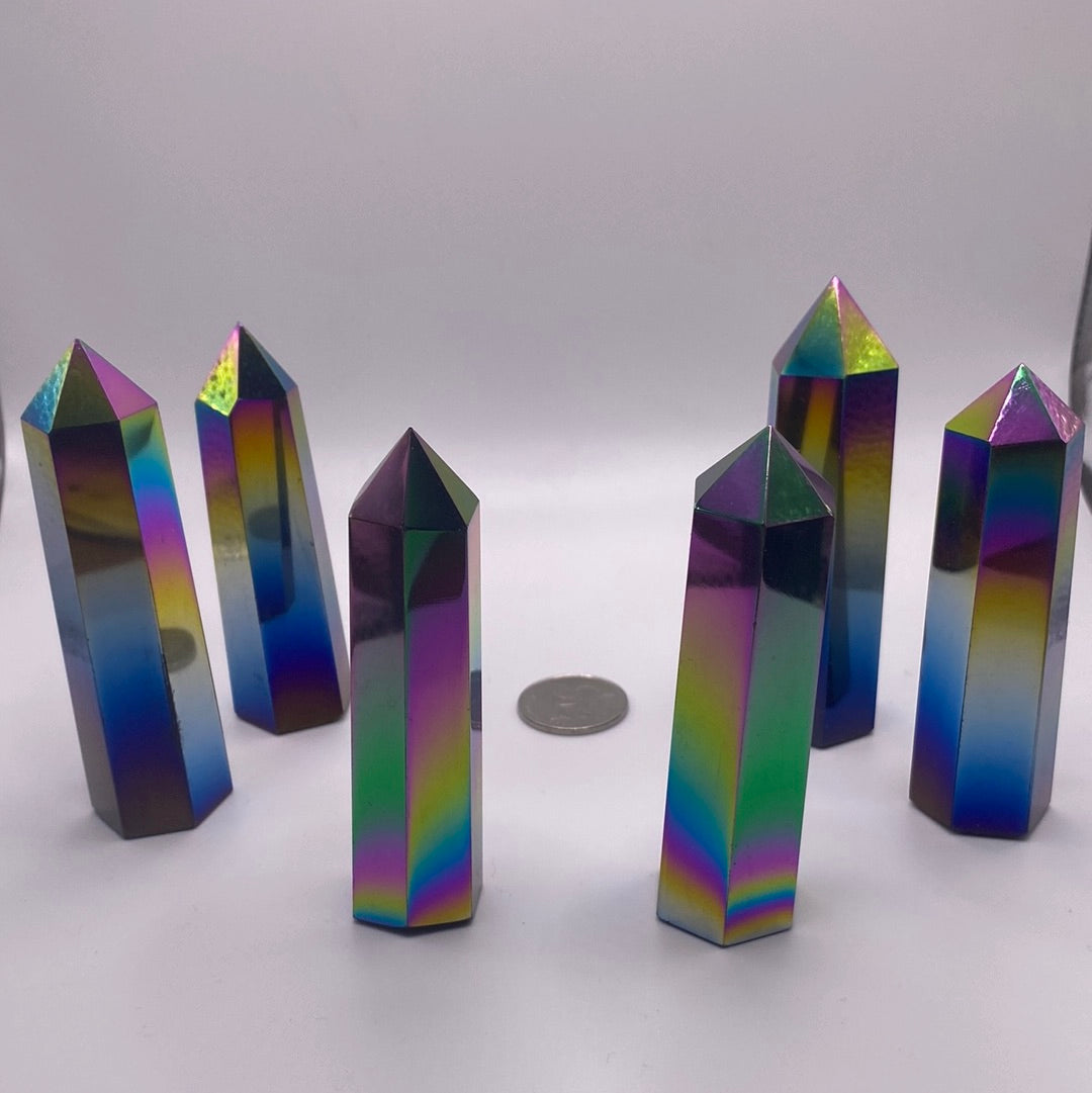 A collection of Black Obsidian Titanium Polished Points showcasing their unique shapes and glossy finish, reflecting light beautifully.