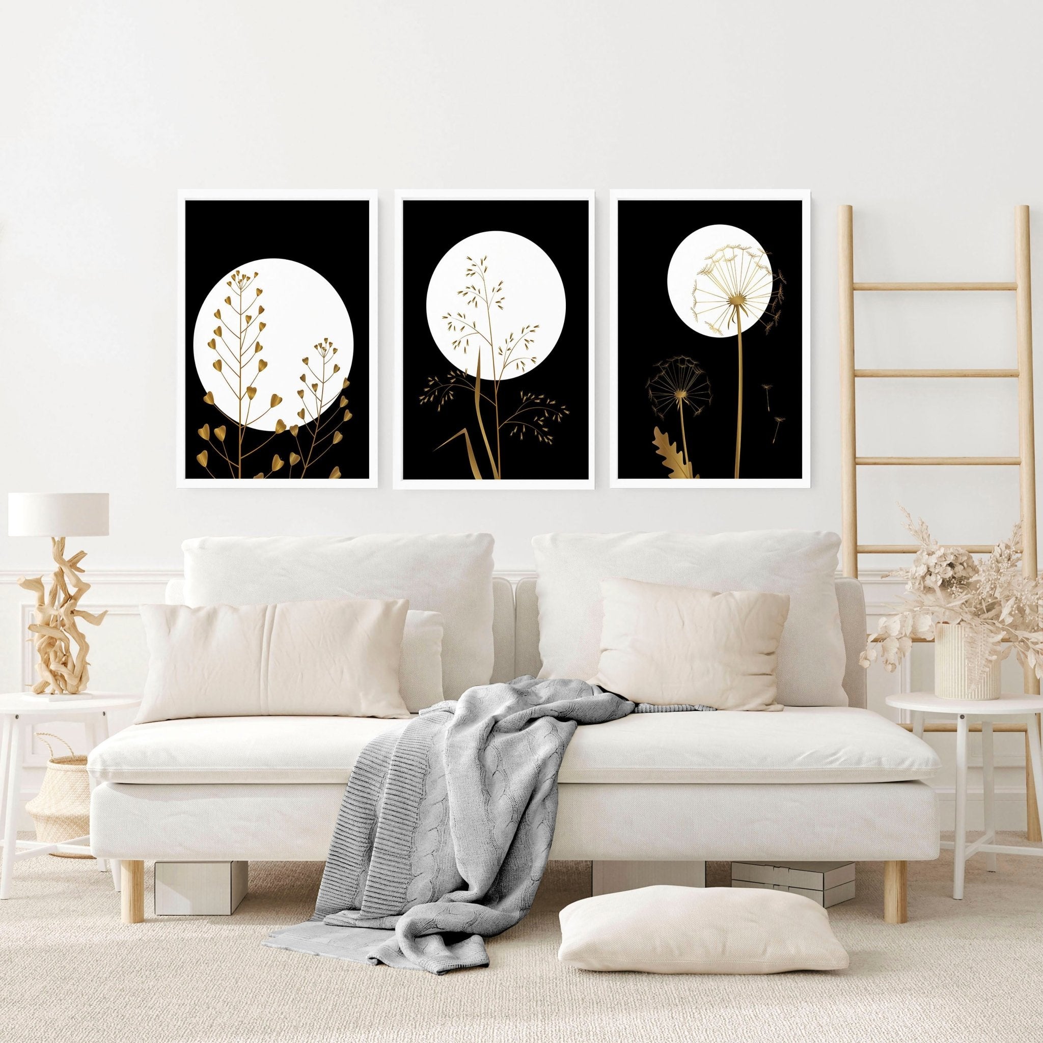 Set of 3 black wall art prints featuring intricate boho botanical designs with shimmering gold details, perfect for living room decor.
