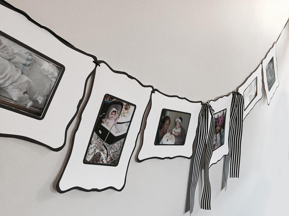 Black & White Frame Garland with 7 frames and decorative ribbons, perfect for showcasing photos.