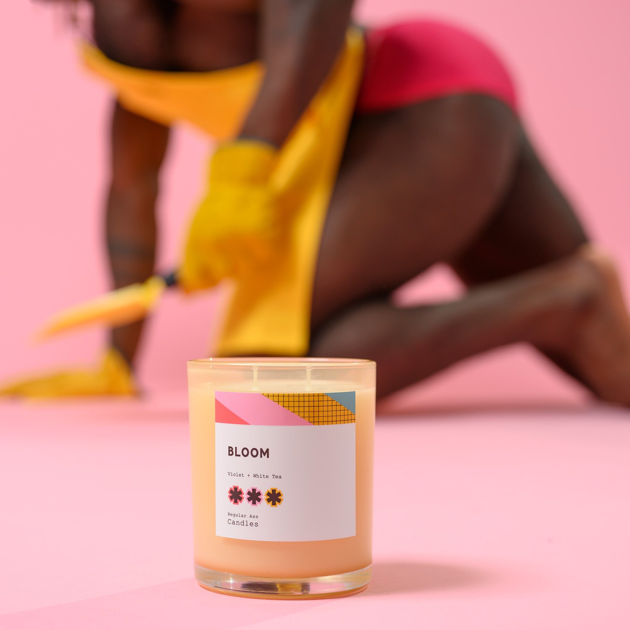 Bloom, Violet + White Tea 11oz Candle in a reusable jar with floral design, showcasing its eco-friendly and elegant appeal.