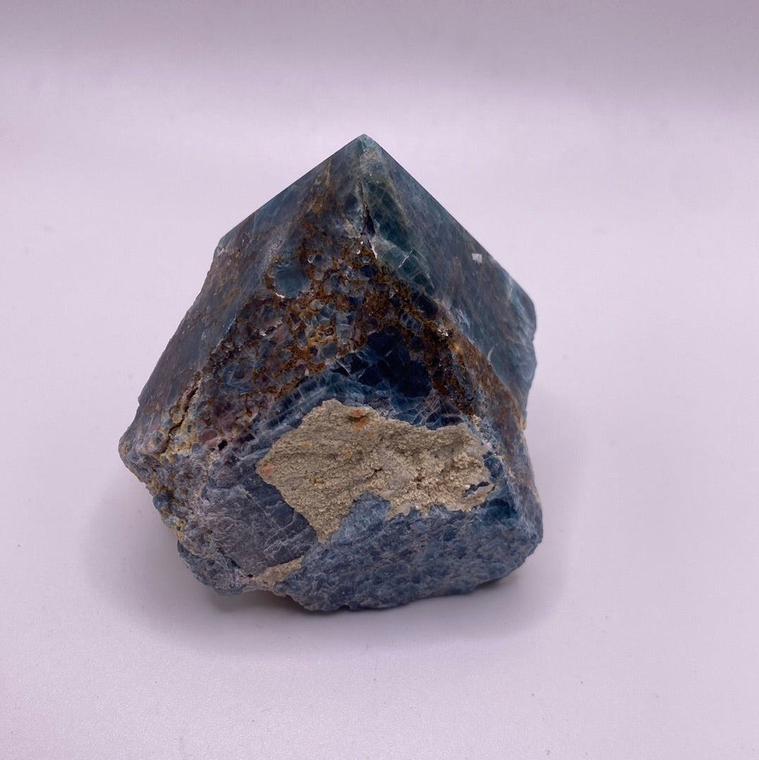 A polished blue apatite point showcasing its deep aqua color and smooth surface, perfect for healing and meditation.