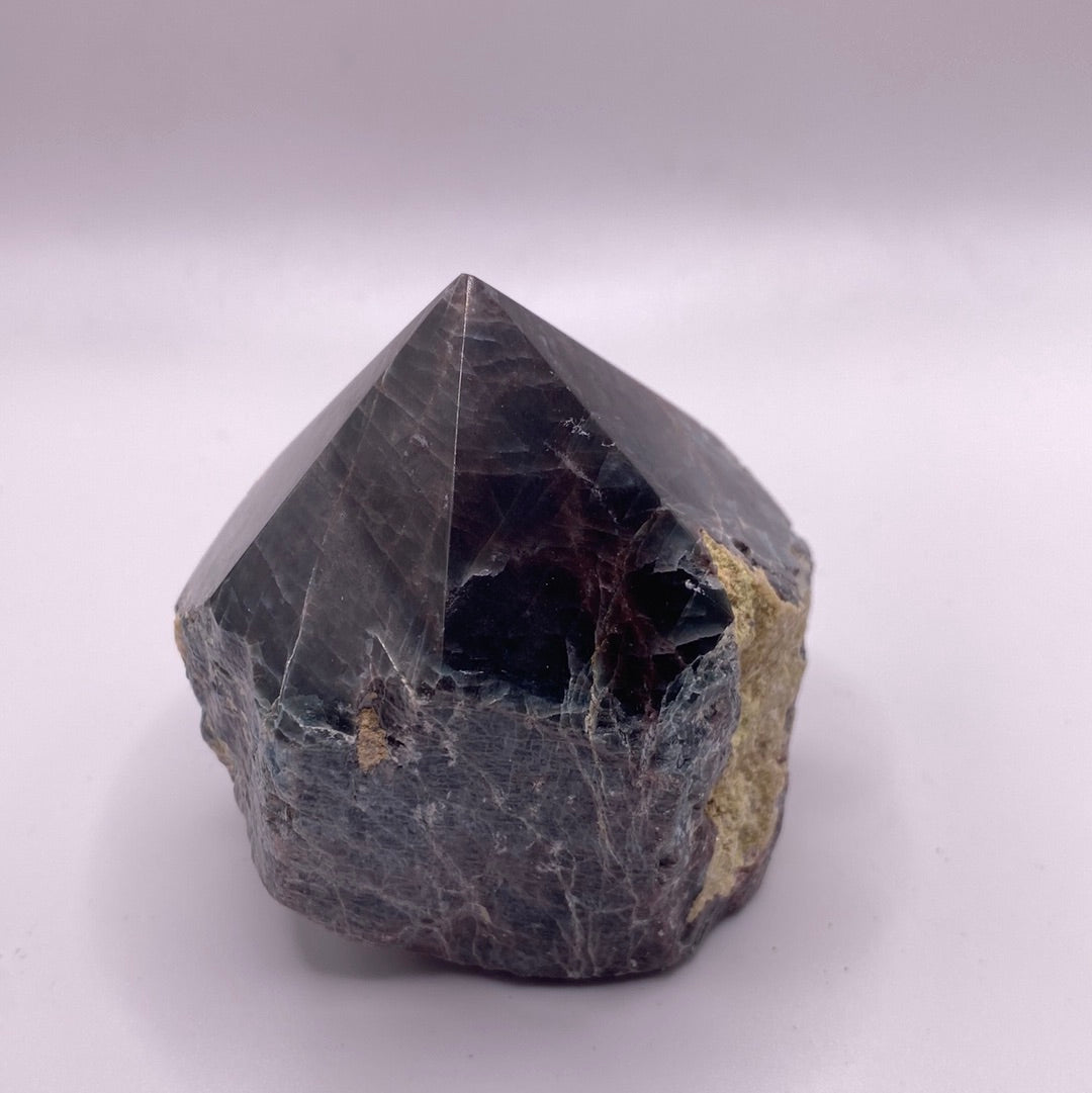 A polished blue apatite point showcasing its deep aqua color and smooth surface, perfect for healing and meditation.