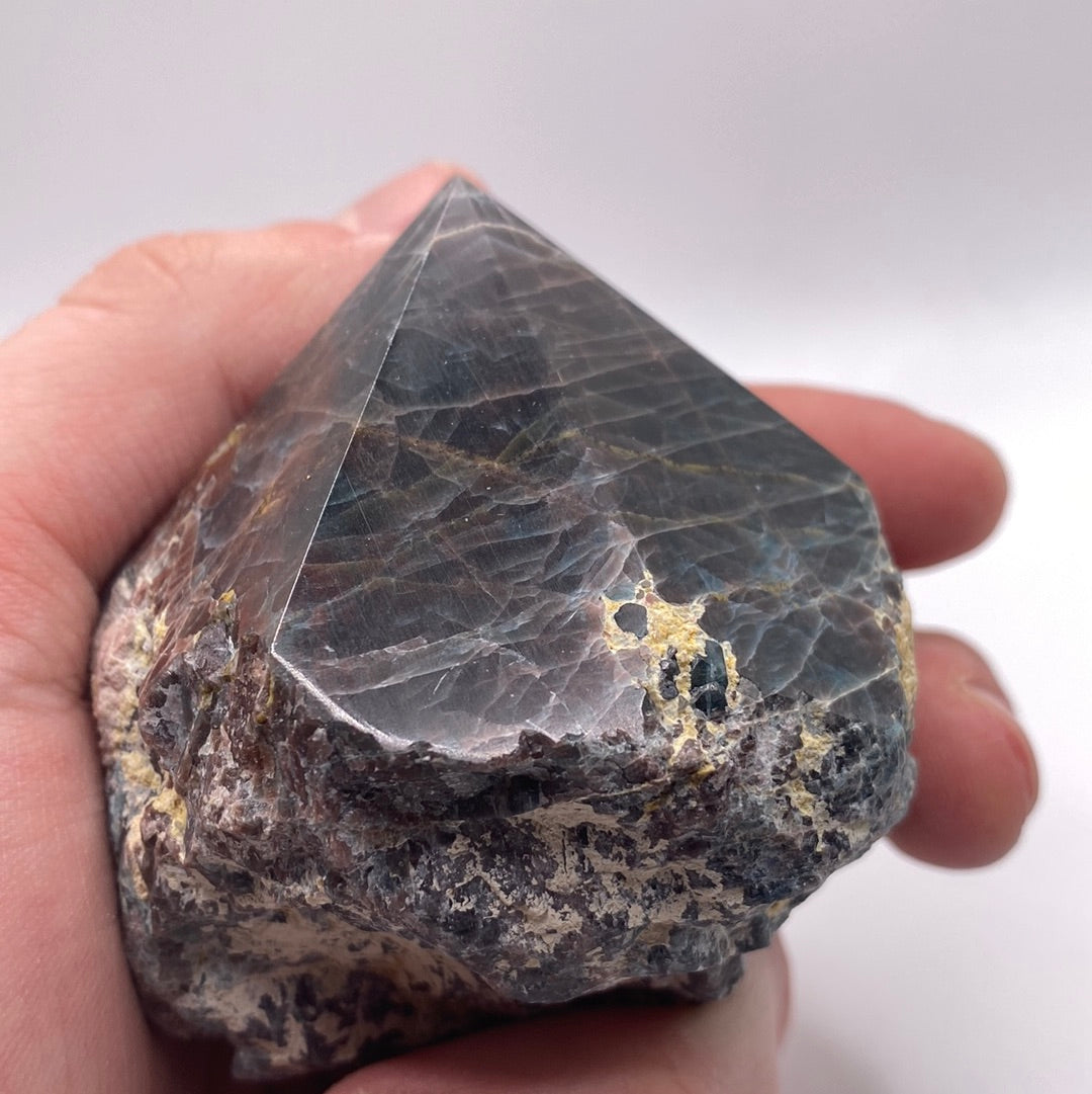 A polished blue apatite point showcasing its deep aqua color and smooth surface, perfect for healing and meditation.