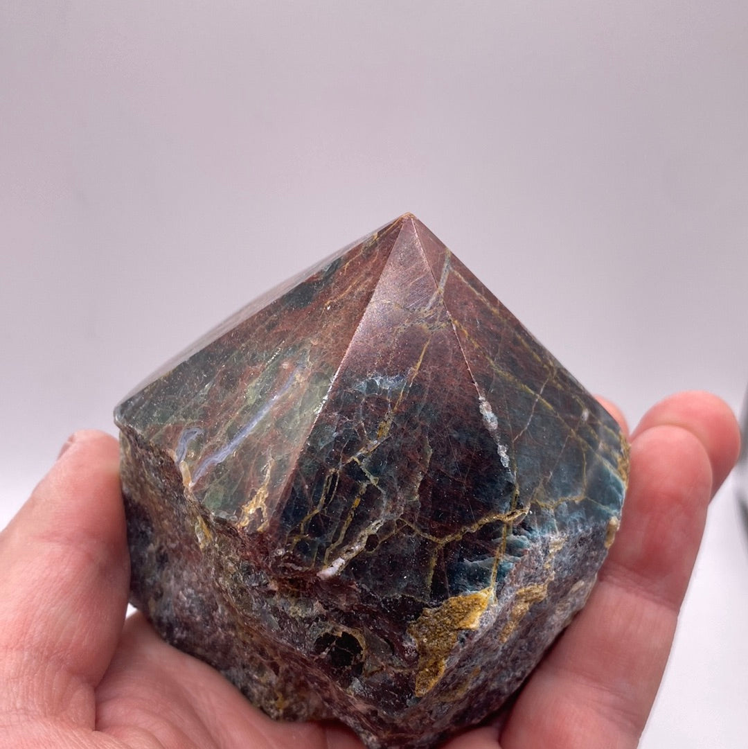 A polished blue apatite point showcasing its deep aqua color and smooth surface, perfect for healing and meditation.