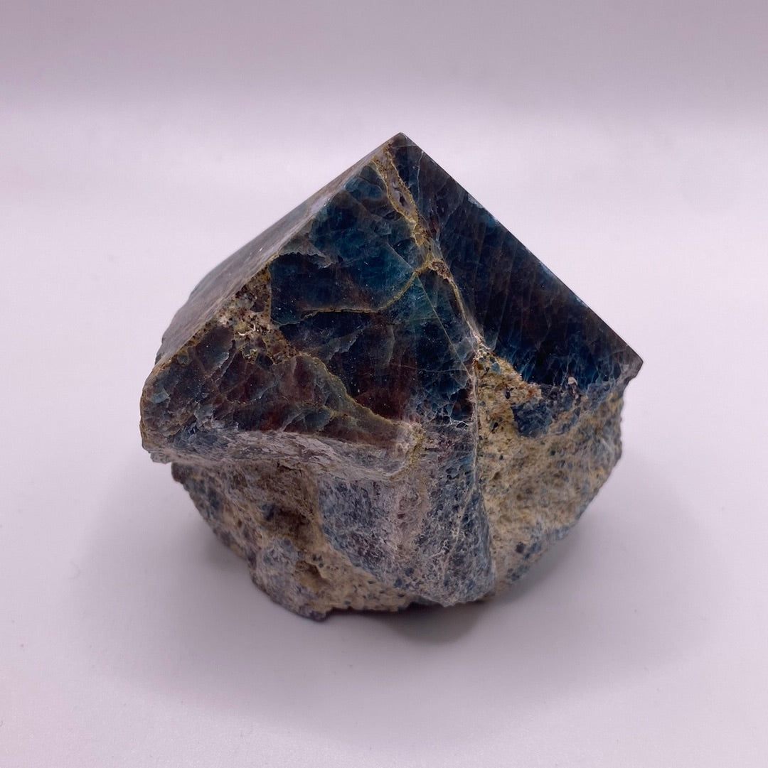 A polished blue apatite point showcasing its deep aqua color and smooth surface, perfect for healing and meditation.