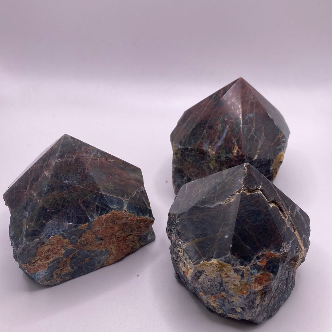 A polished blue apatite point showcasing its deep aqua color and smooth surface, perfect for healing and meditation.