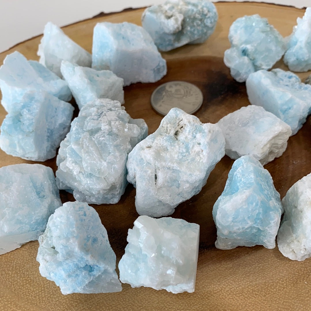 A rough cut piece of blue aragonite showcasing its natural texture and calming blue hues, perfect for grounding and meditation.