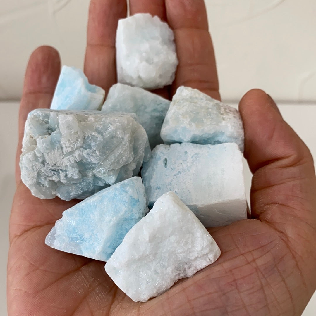 A rough cut piece of blue aragonite showcasing its natural texture and calming blue hues, perfect for grounding and meditation.