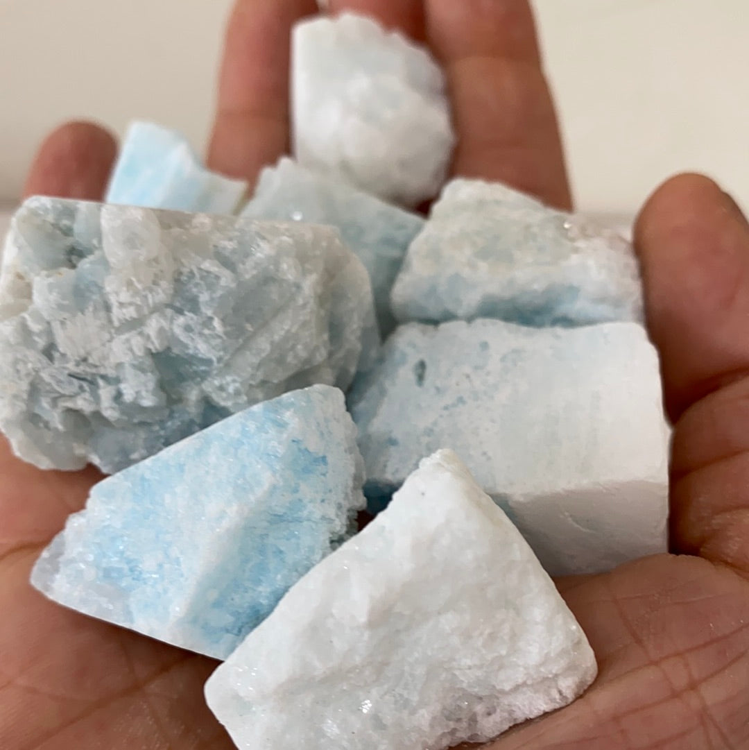 A rough cut piece of blue aragonite showcasing its natural texture and calming blue hues, perfect for grounding and meditation.
