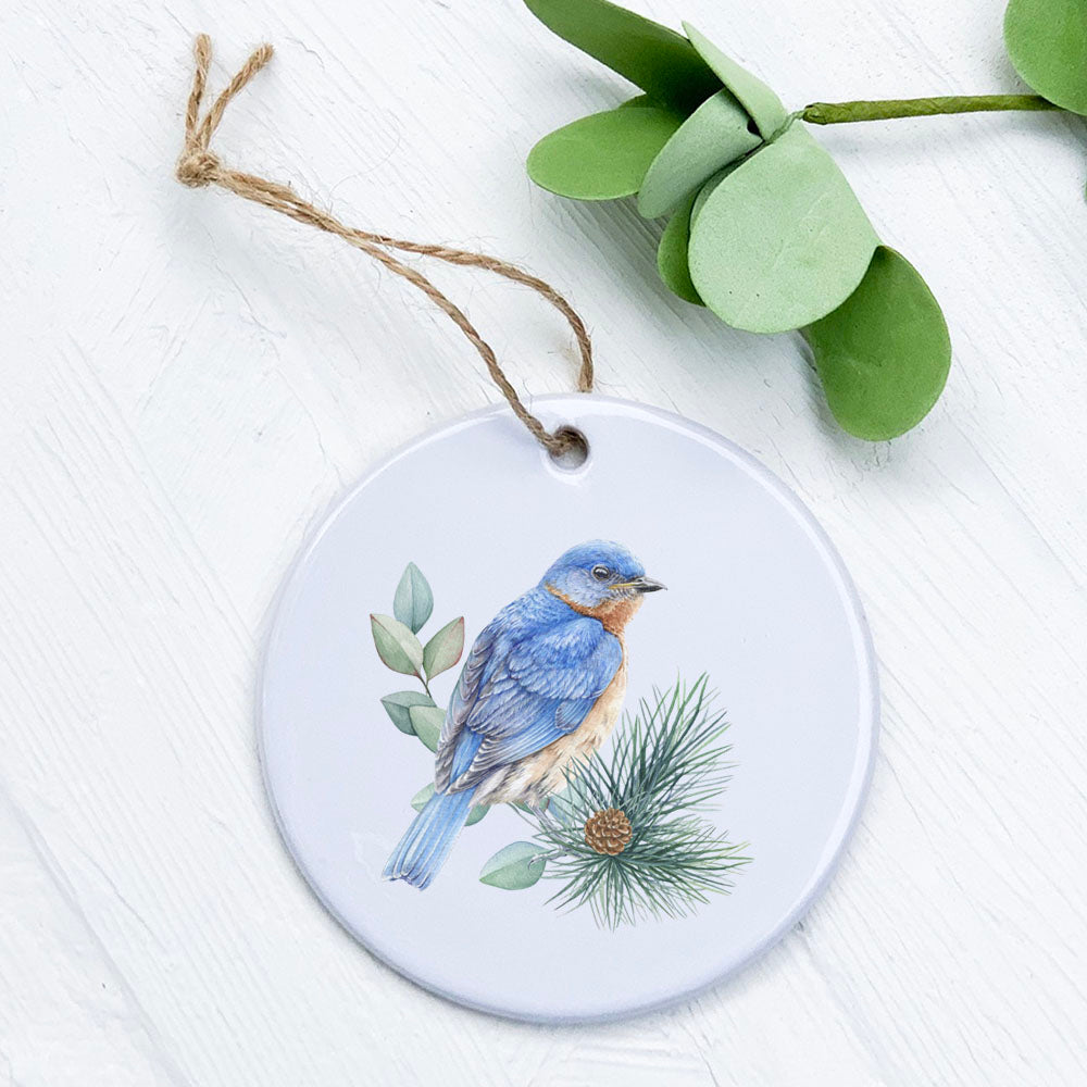 A beautifully crafted Blue Bird porcelain ornament with vibrant colors and a smooth gloss finish, measuring 2.75 inches in diameter.