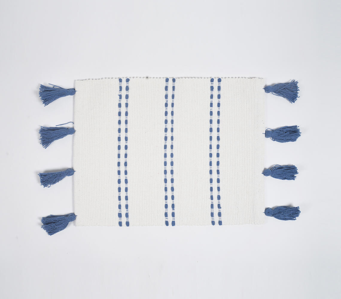 Set of four blue dotted lines cotton placemats with tassel decoration, showcasing handwoven craftsmanship and elegant design.