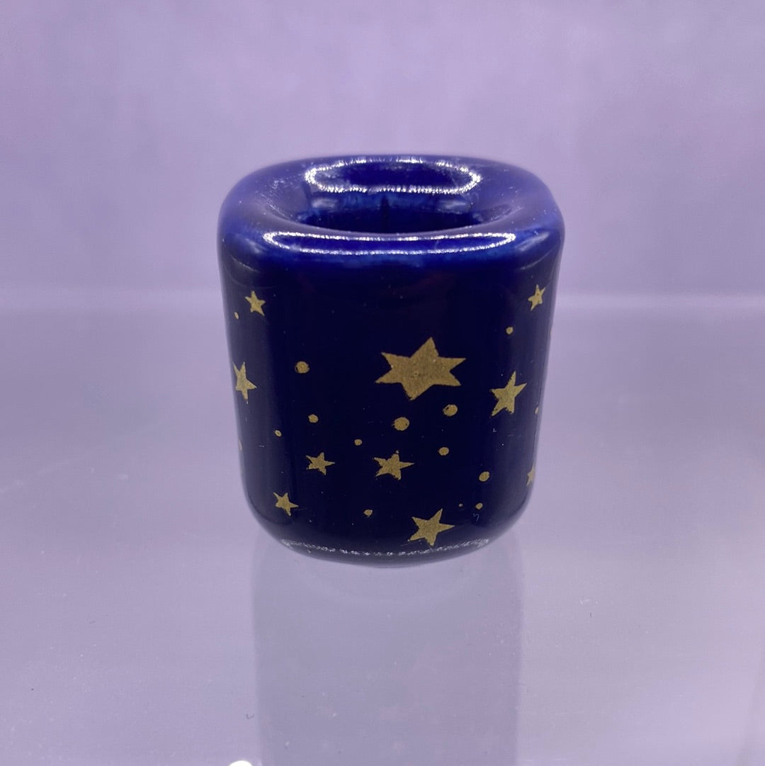 A beautiful blue porcelain candle holder adorned with gold stars, designed to fit a 1/2 inch candle, perfect for candle magic.
