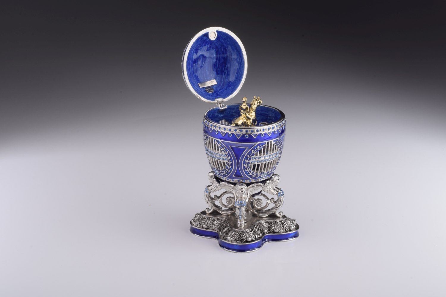 A beautifully crafted Blue Russian Egg trinket box featuring a man riding a horse, adorned with Austrian crystals and 24K gold plating.