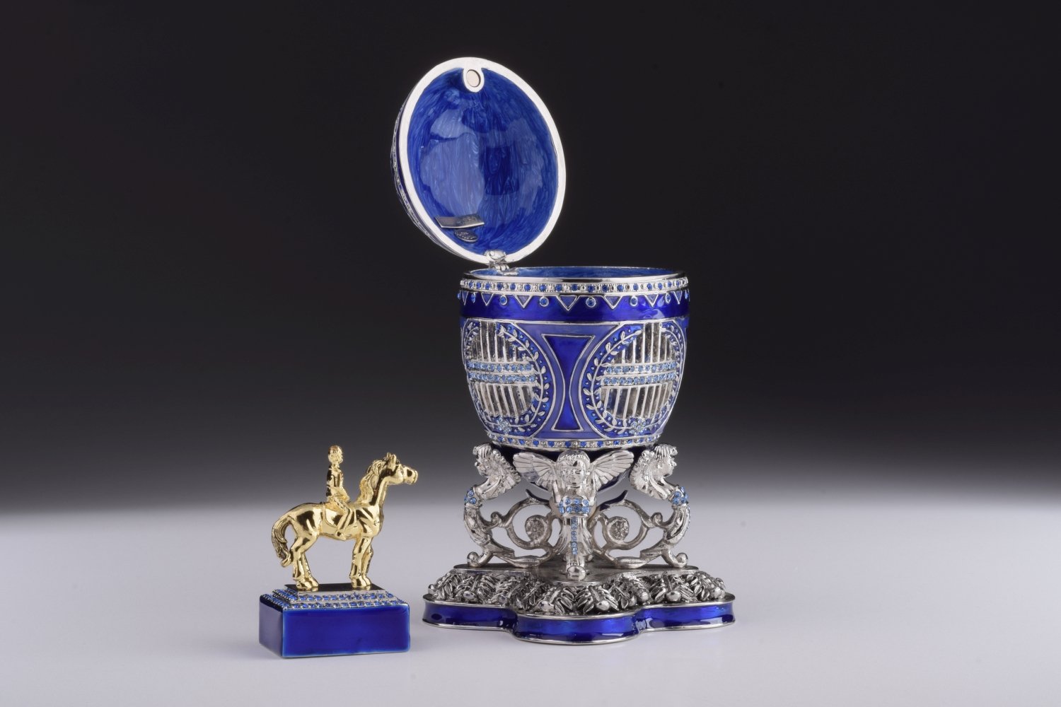A beautifully crafted Blue Russian Egg trinket box featuring a man riding a horse, adorned with Austrian crystals and 24K gold plating.