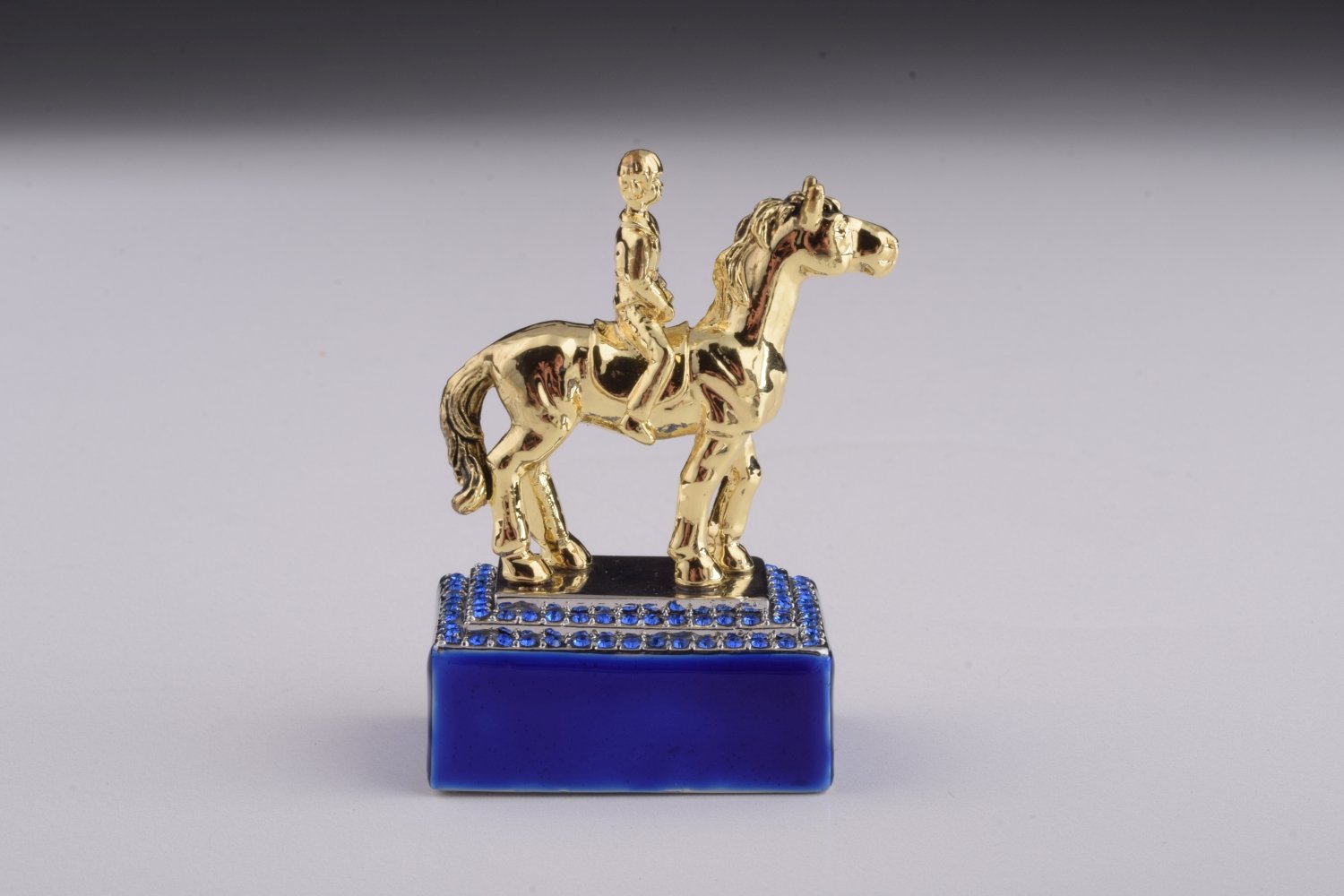 A beautifully crafted Blue Russian Egg trinket box featuring a man riding a horse, adorned with Austrian crystals and 24K gold plating.