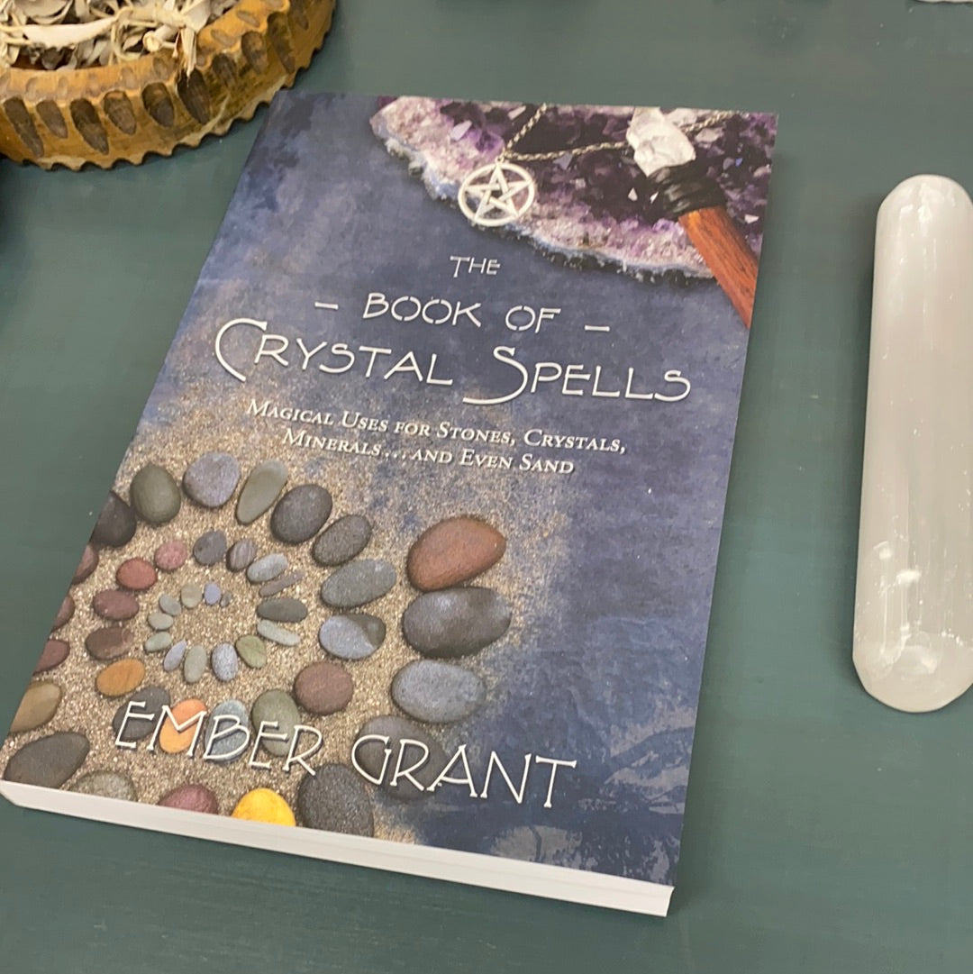 Cover of the Book of Crystal Spells featuring mystical designs and crystal imagery.
