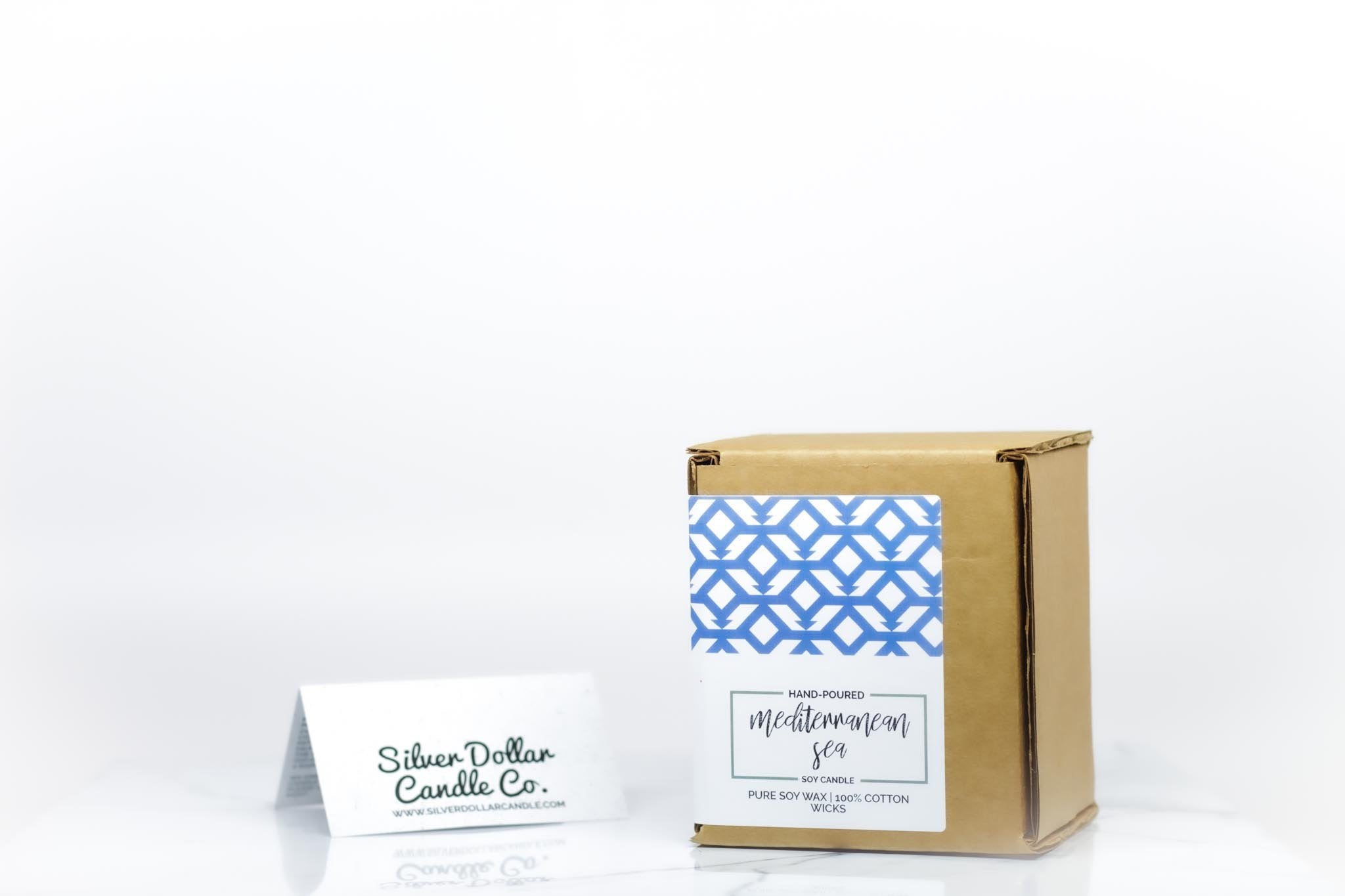 A beautifully designed candle with the phrase 'Books Are Just TV For Smart People', showcasing its elegant packaging and vibrant colors.