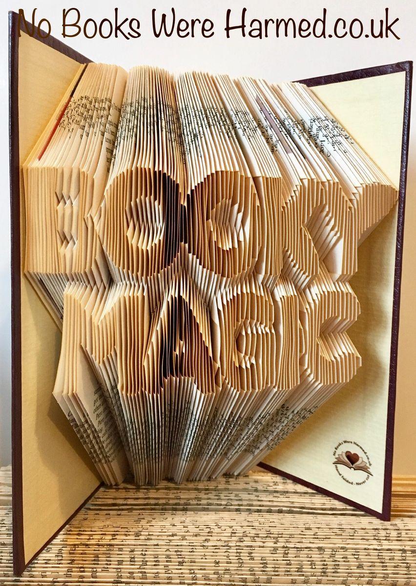 Handcrafted book art made from vintage pages, showcasing intricate folds and unique designs.