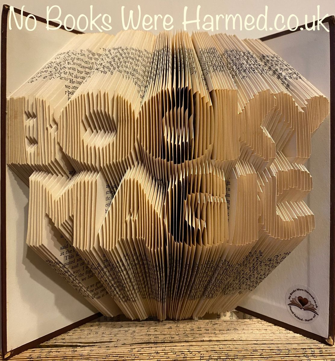 Handcrafted book art made from vintage pages, showcasing intricate folds and unique designs.