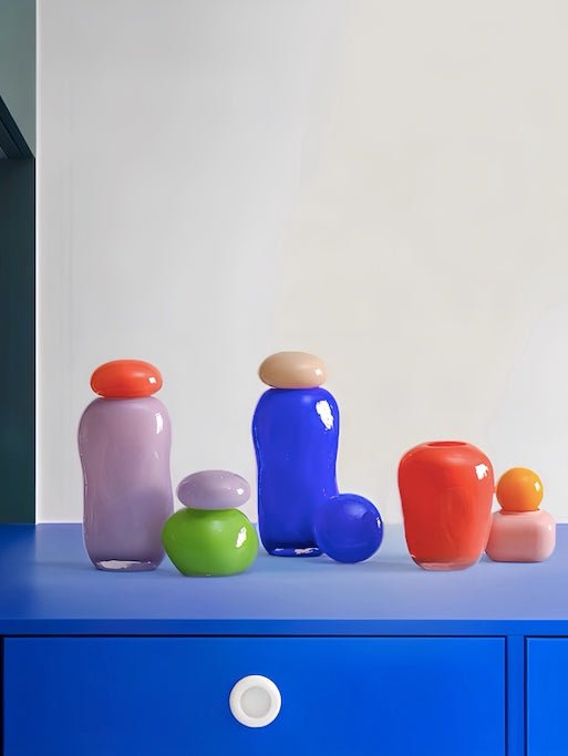 A whimsical Bonbon Glass Jar Ornament in vibrant colors, perfect for home decor and as a bud vase.