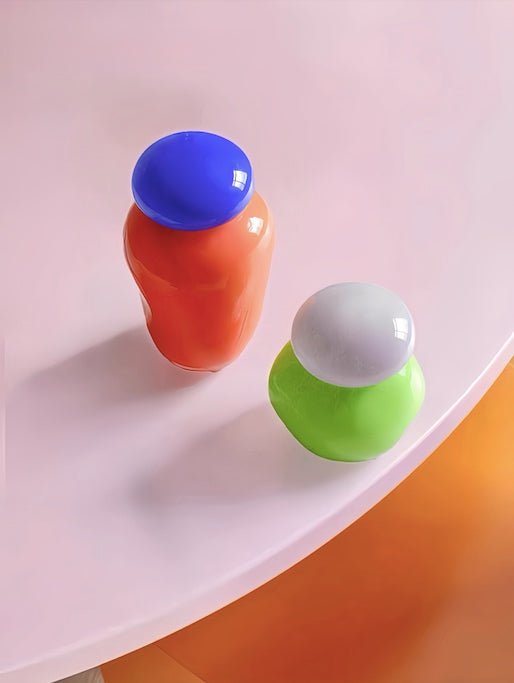 A whimsical Bonbon Glass Jar Ornament in vibrant colors, perfect for home decor and as a bud vase.