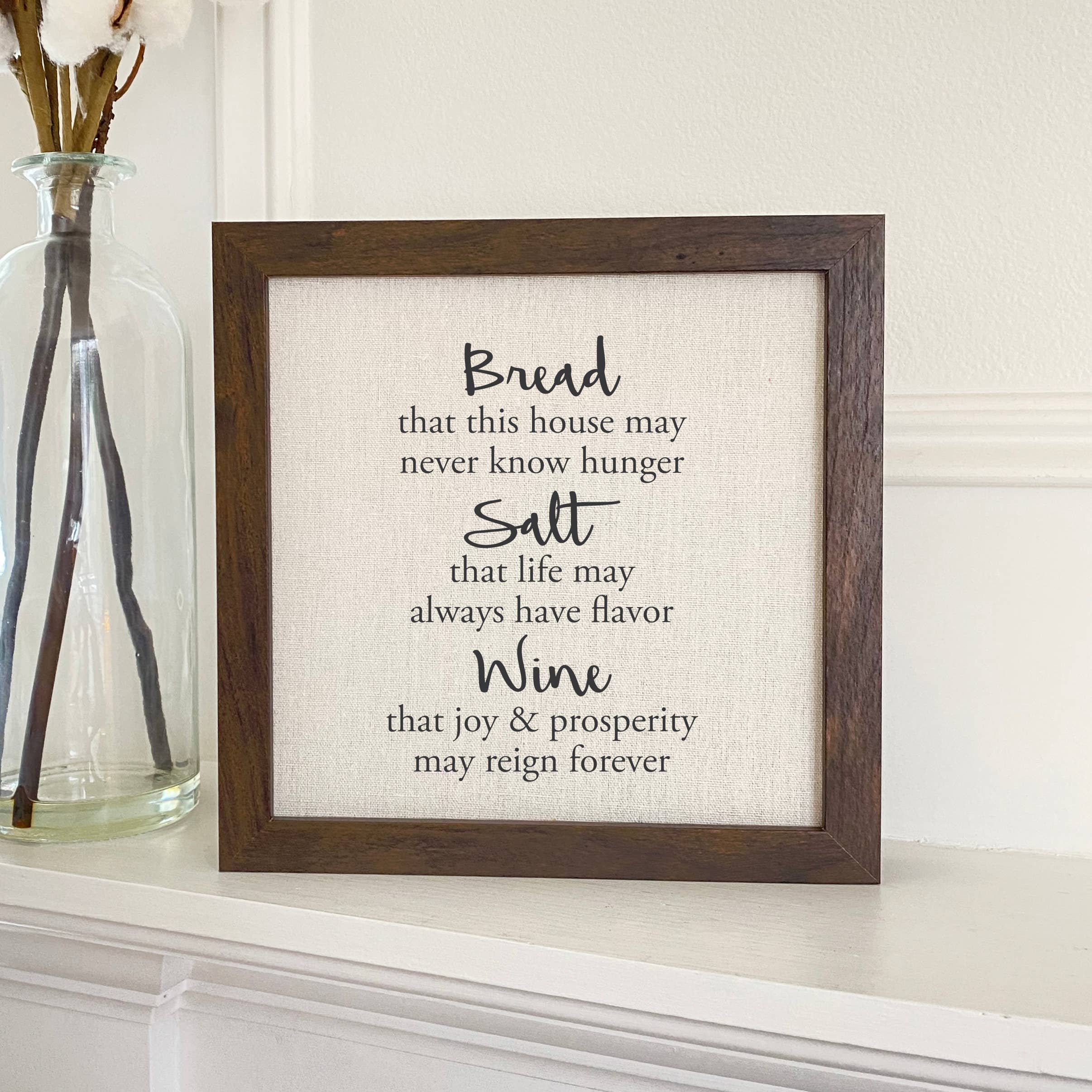 A beautifully framed sign reading 'Bread, Salt, Wine' with a linen-look background and wooden frame options.
