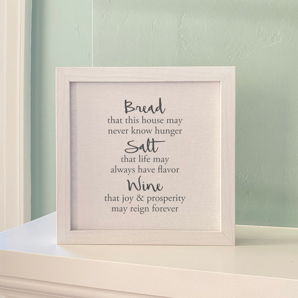 A beautifully framed sign reading 'Bread, Salt, Wine' with a linen-look background and wooden frame options.