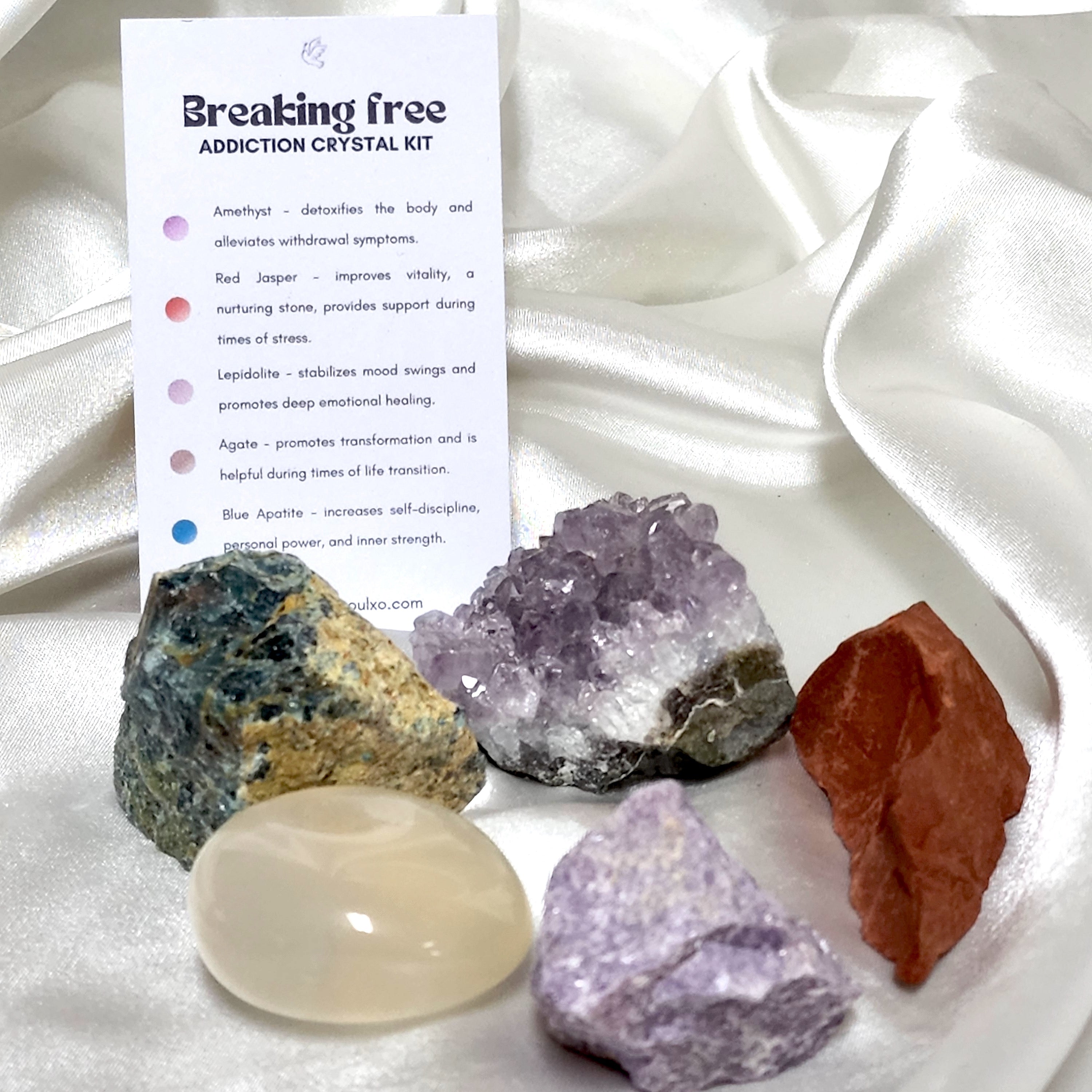 Breaking Free Addiction Crystal Kit featuring Lepidolite, Agate, Amethyst, Blue Apatite, and Red Jasper in a decorative arrangement.
