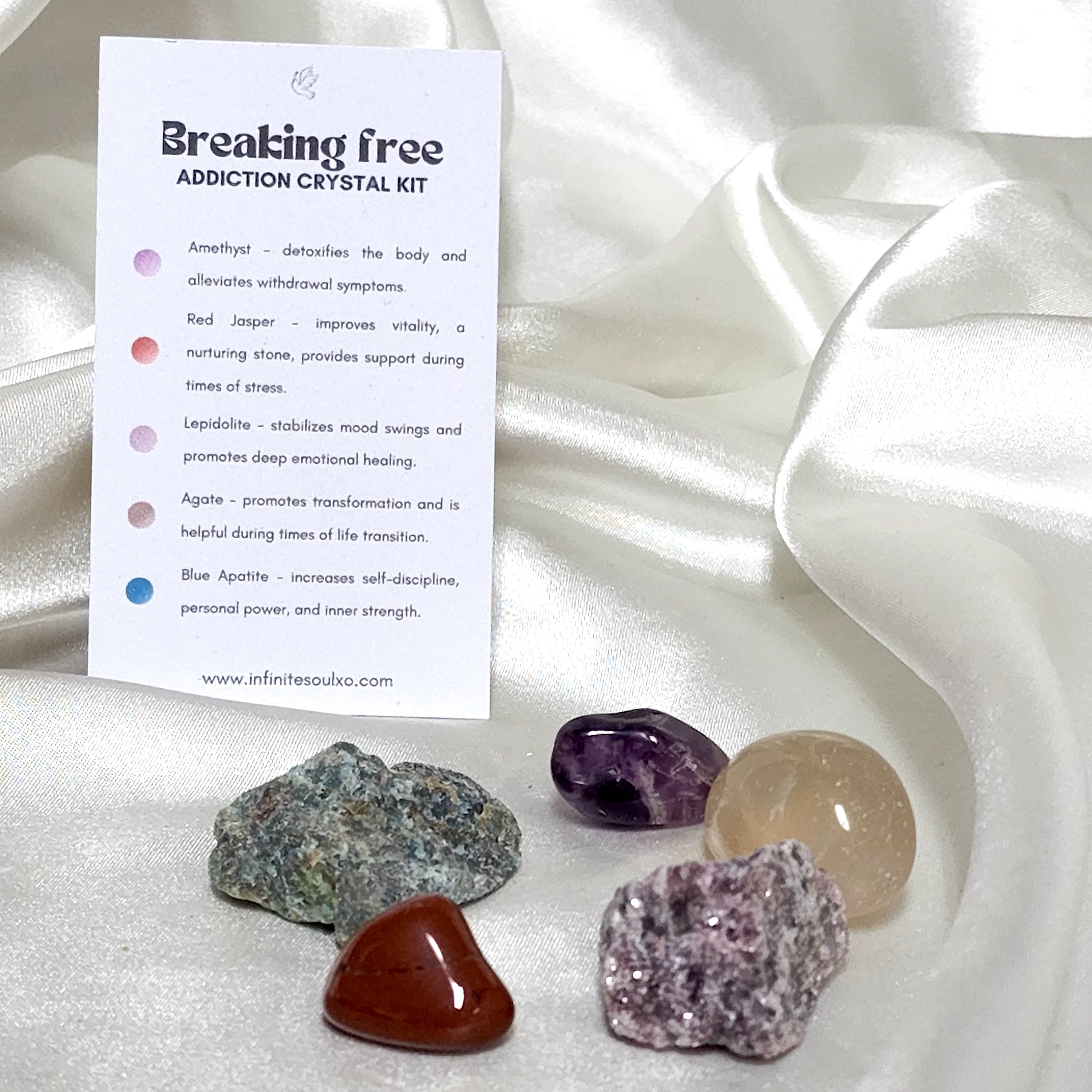 Breaking Free Addiction Crystal Kit featuring Lepidolite, Agate, Amethyst, Blue Apatite, and Red Jasper in a decorative arrangement.