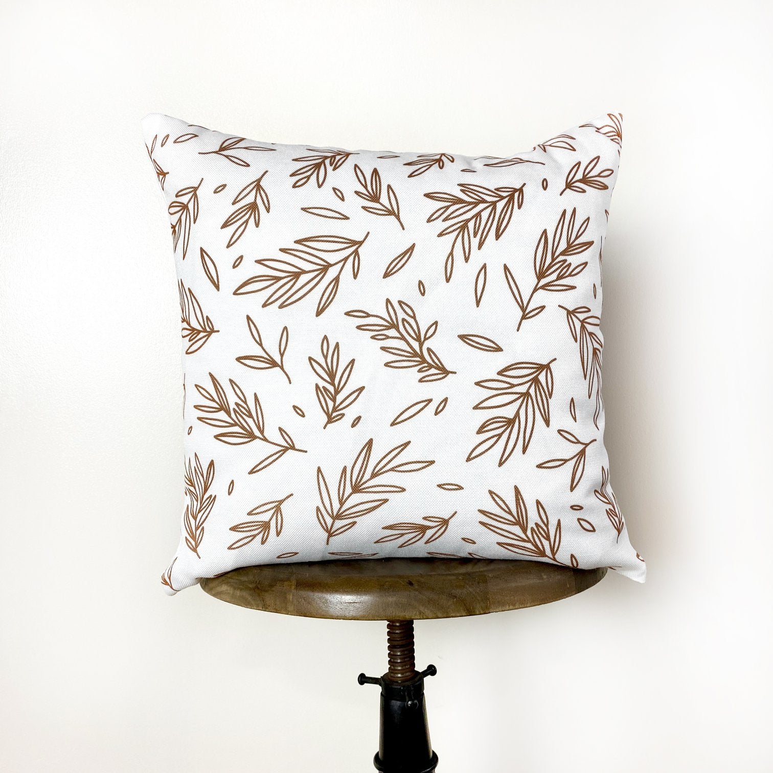 Brown Leaf Repeat Pattern Throw Pillow Cover on a white background, showcasing its charming design and concealed zipper.