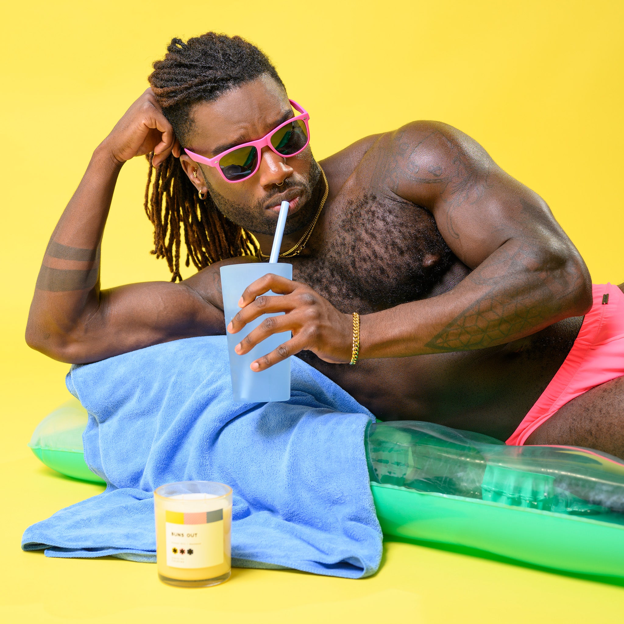 Buns Out Coconut Milk + Beachwood 11oz Candle in a stylish jar, showcasing its tropical scent and eco-friendly design.