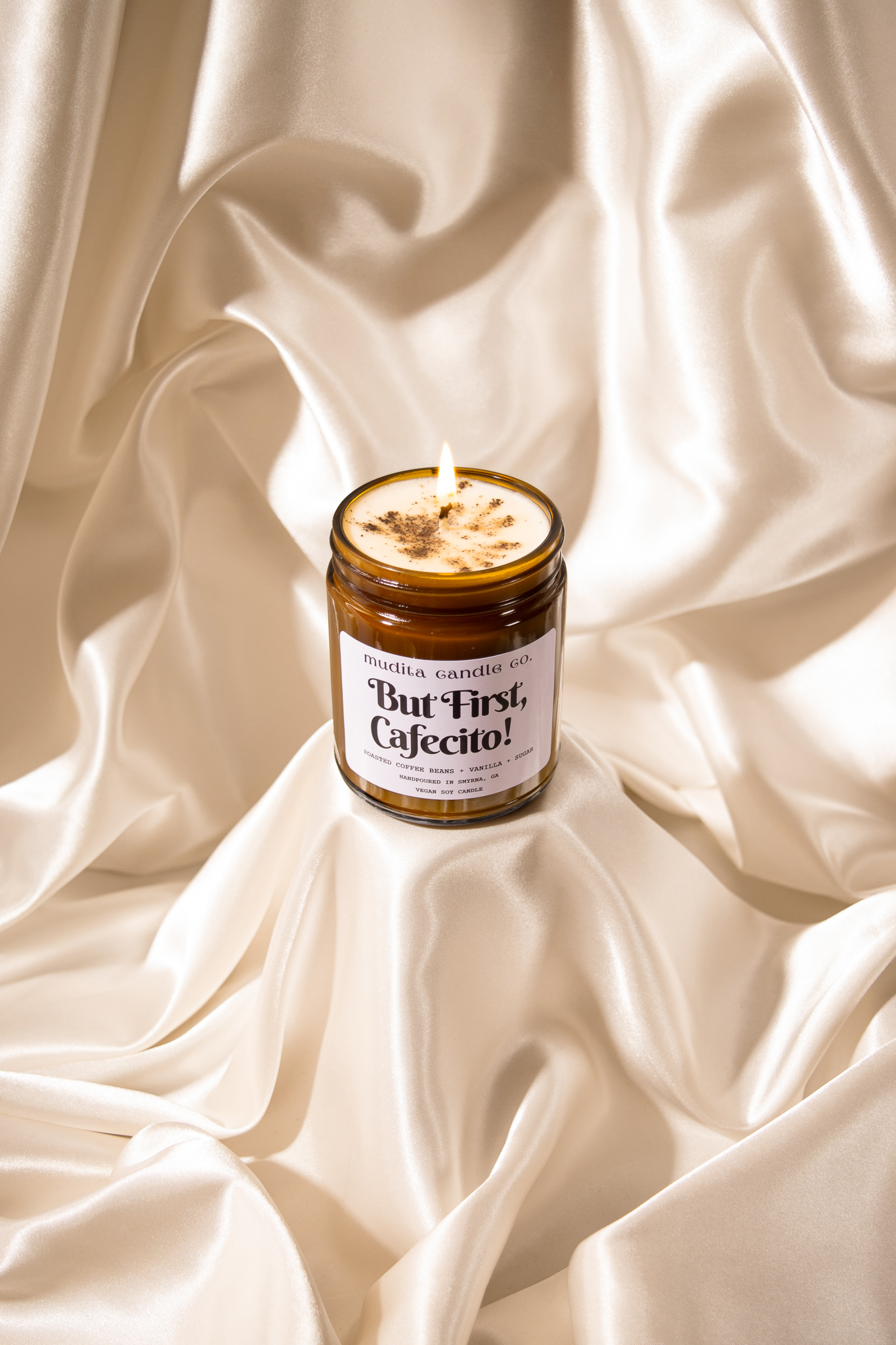 But First, Cafecito! Coffee Vanilla Soy Candle in a reusable amber glass jar with a gold lid, showcasing its inviting aroma.