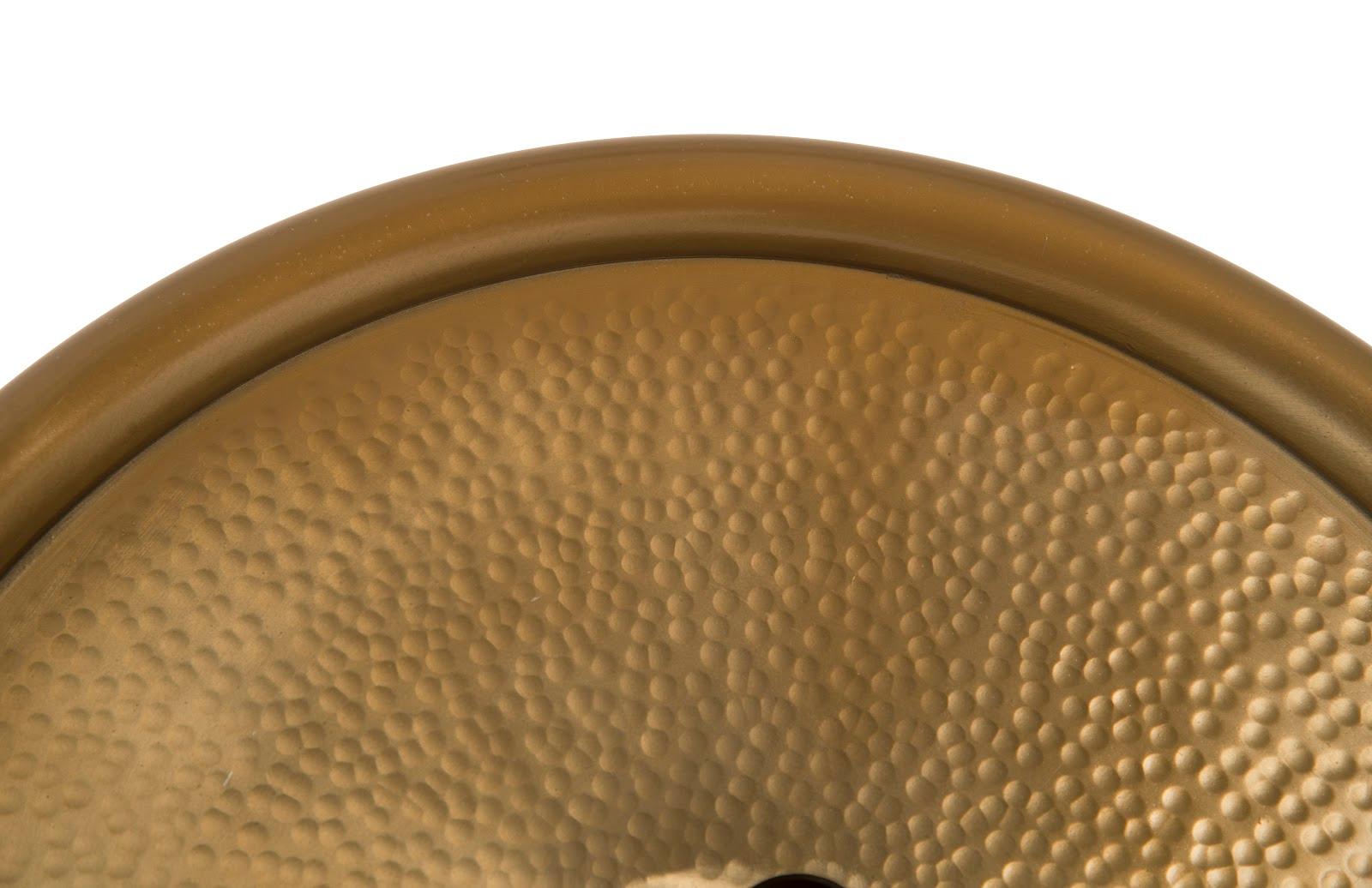 Button Wall Tile featuring a hammered metal design with a brass finish, showcasing its oversized button shape and intricate texture.