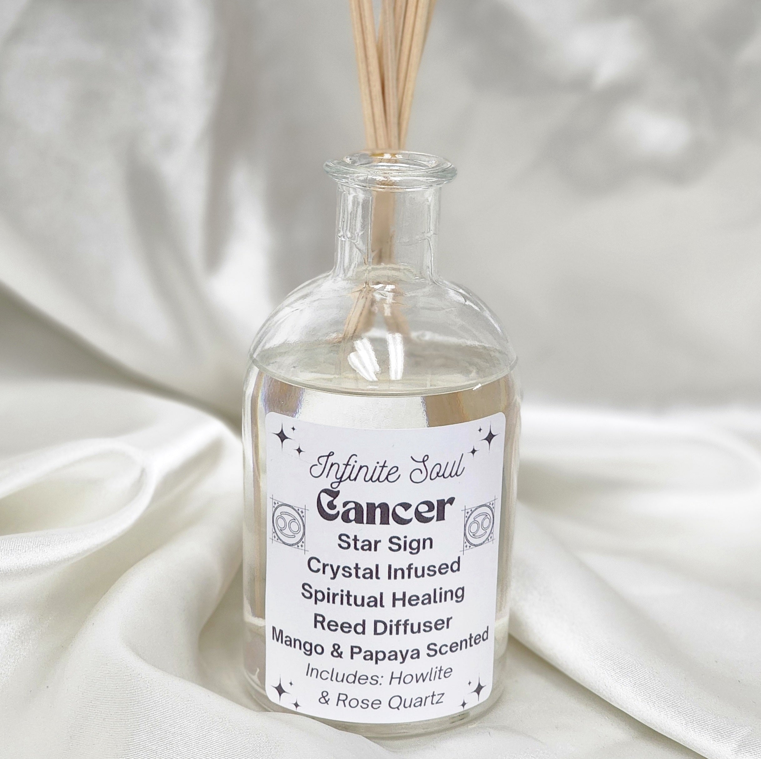 Cancer Star Sign Reed Diffuser with mango and papaya scent, featuring Howlite and Rose Quartz crystals for healing.