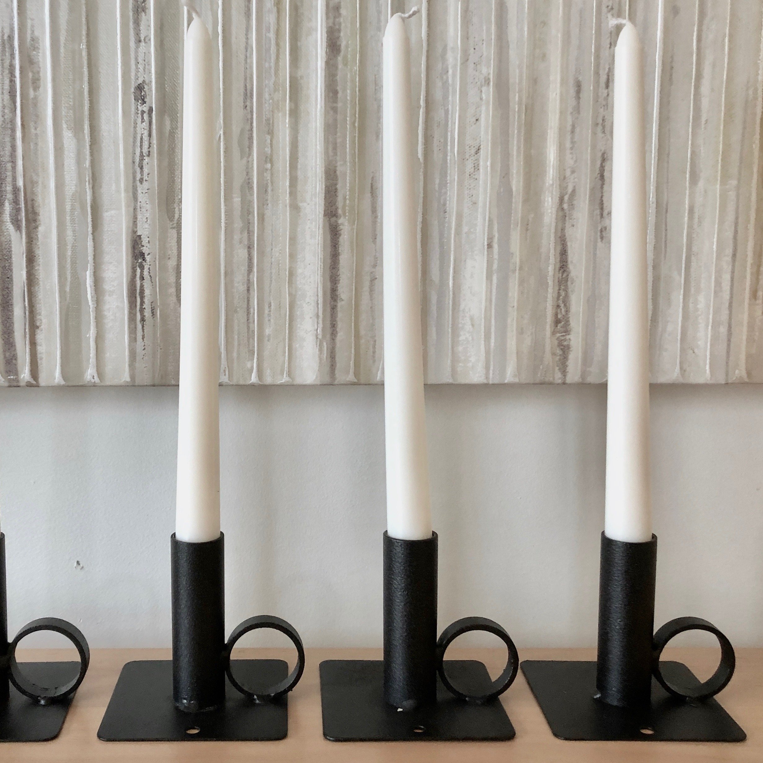 WIM candlestick by ZOOI, handcrafted from metal scraps, featuring a minimalist design with a base plate to catch wax drips.