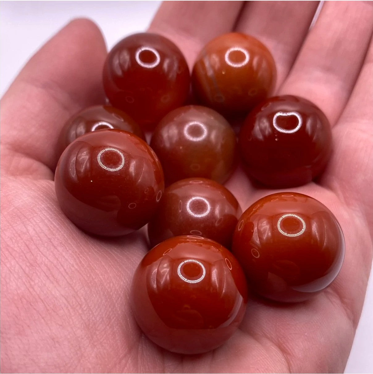 A vibrant 20mm Carnelian Sphere showcasing warm orange hues, symbolizing protection and creativity, perfect for meditation and crystal grids.