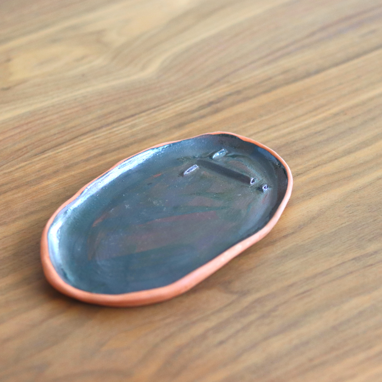 Ceramic Handmade Decorative Tray featuring intricate face details in a deep navy speckled finish, showcasing artisan craftsmanship.