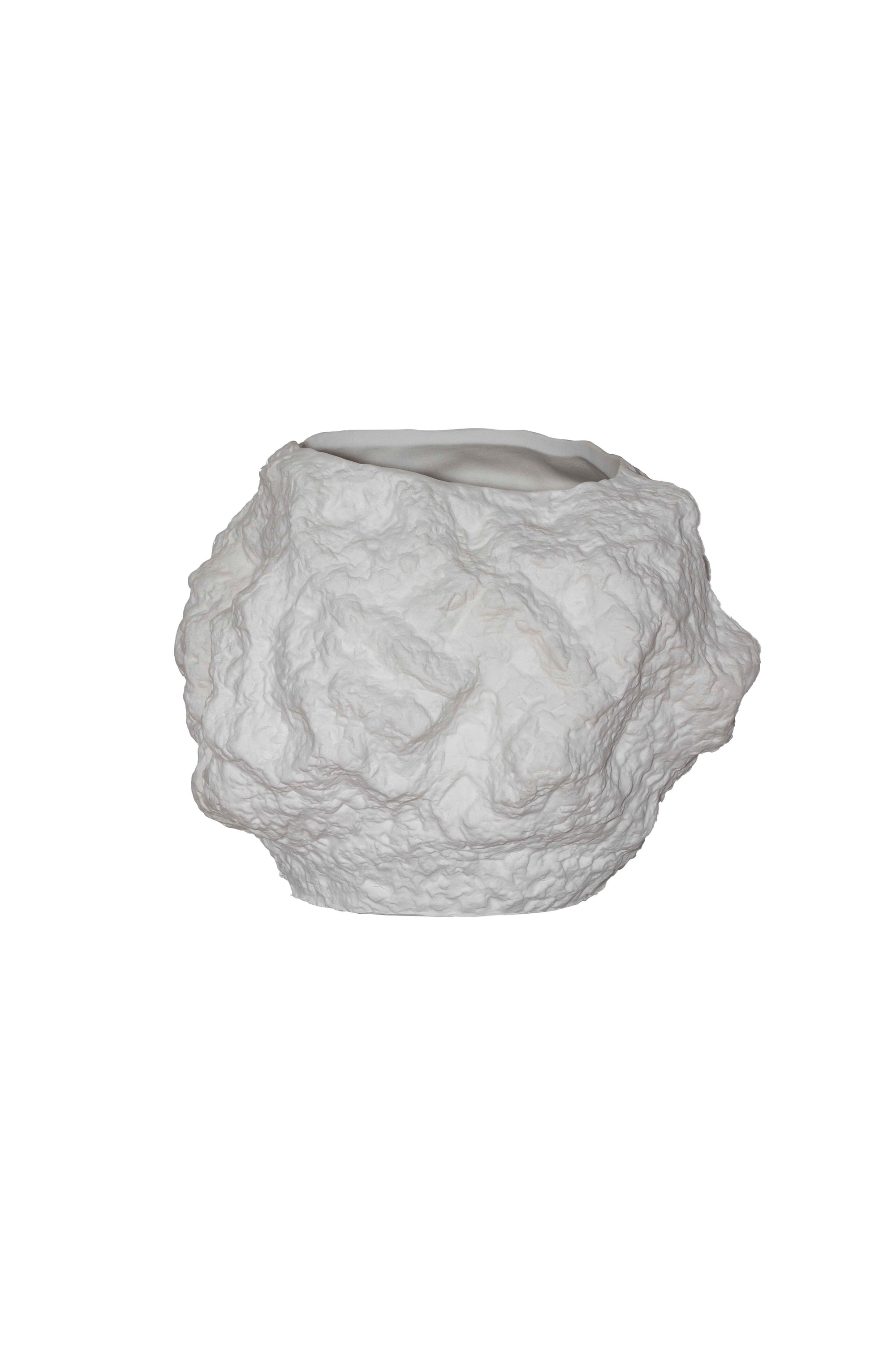 A stylish ceramic vase designed to resemble a rock, featuring a trendy white color and unique shape, perfect for floral arrangements.