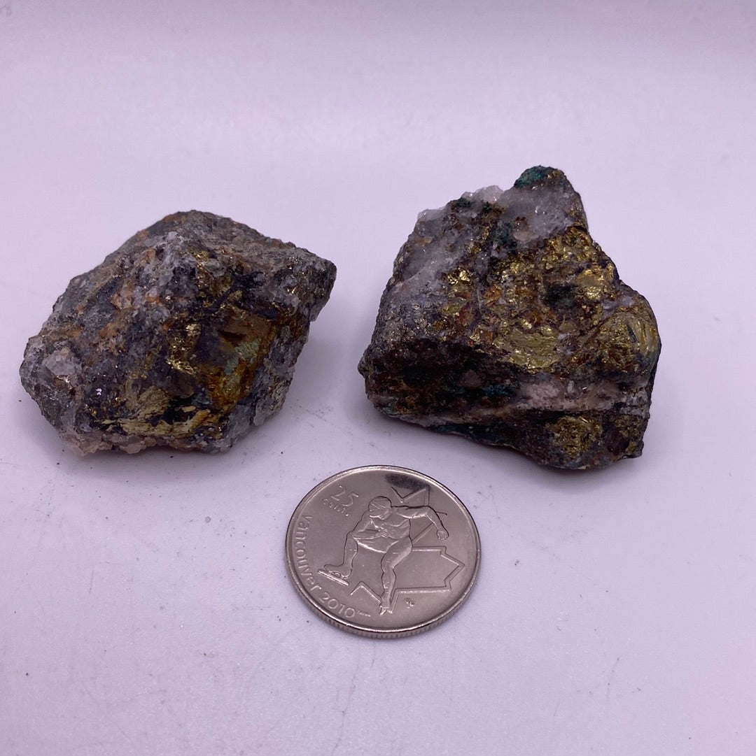 A stunning Chalcopyrite specimen showcasing its brass-yellow metallic luster and vibrant surface colors of blue, green, and pink.