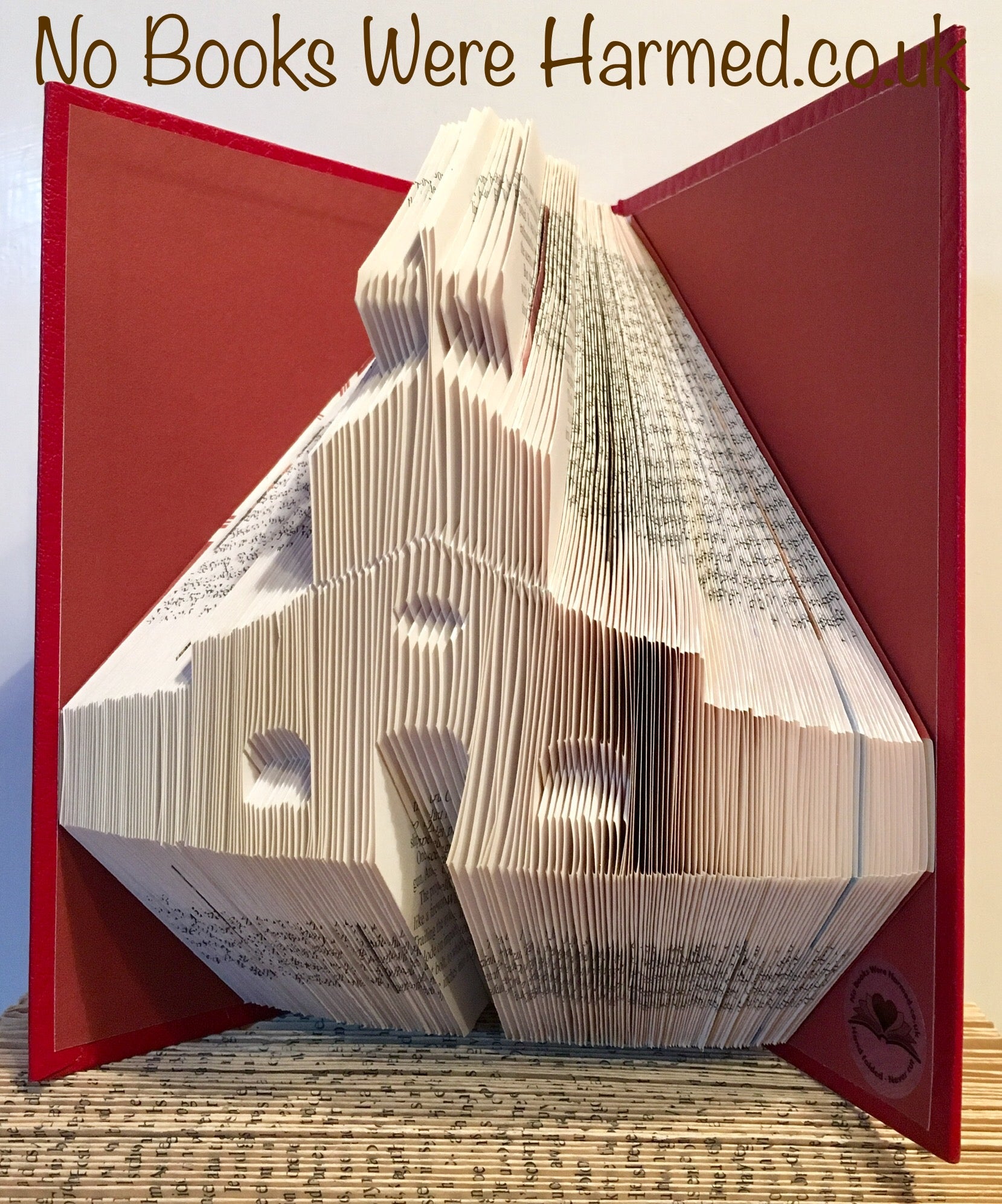 A beautifully crafted chapel art piece made from hand-folded pages of vintage books, showcasing intricate designs and unique textures.