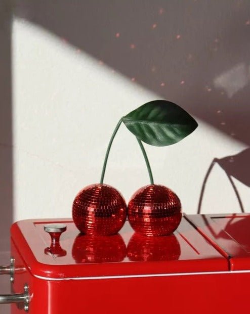 A vibrant Cherry Disco Ball featuring two shiny cherries, perfect for whimsical home decor and party decorations.