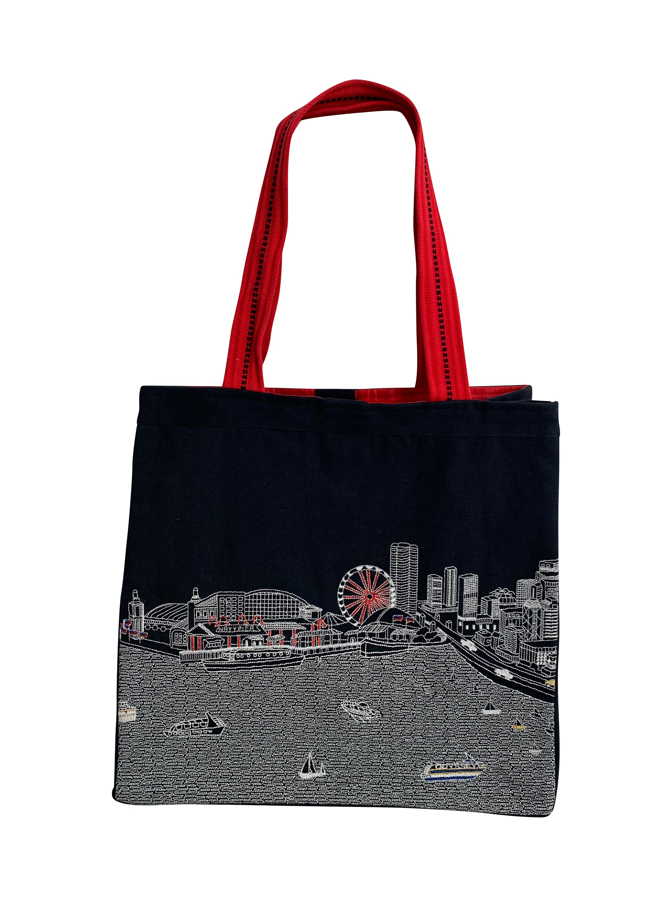 Chicago Tote Bag featuring an embroidered skyline design on cream and black cotton canvas with red waterproof lining and ribbed straps.