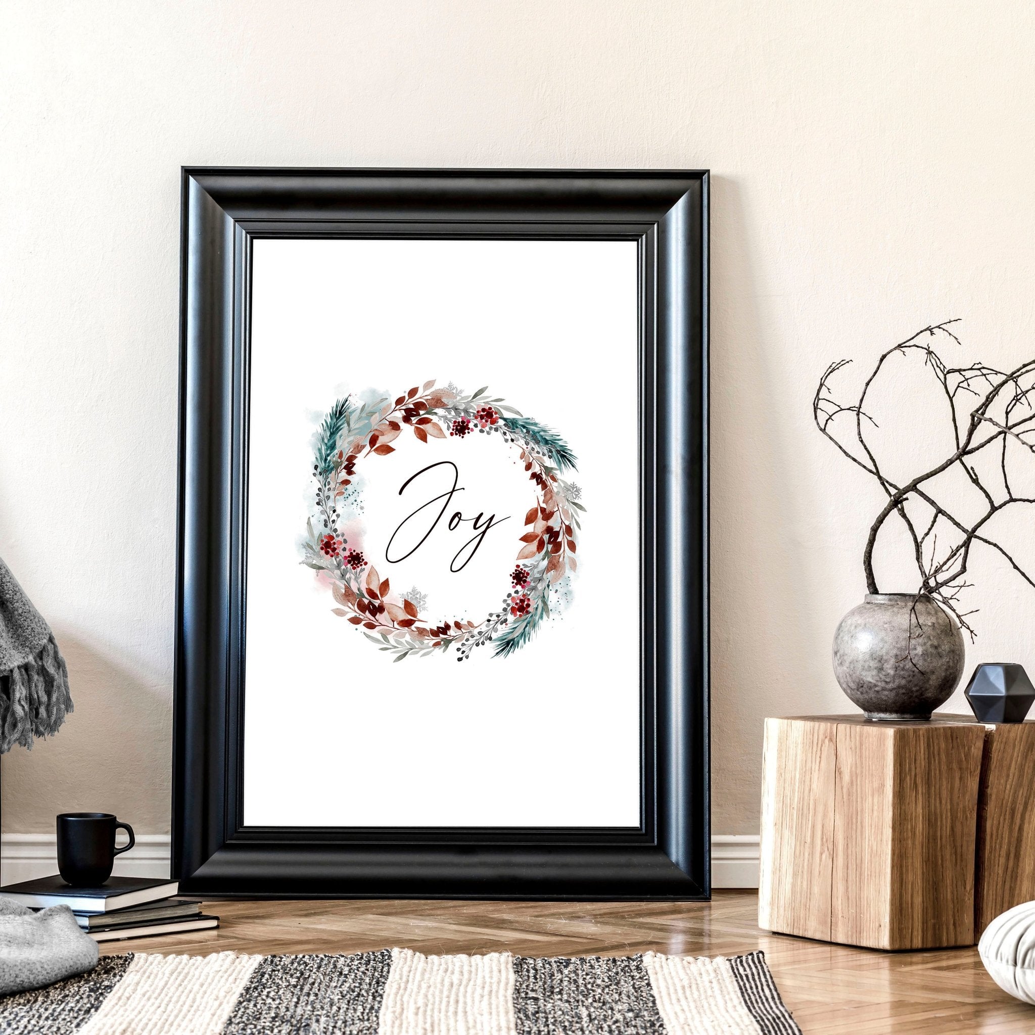 A vibrant watercolour wreath featuring holly leaves and berries with the word 'Joy' elegantly handwritten in the center, perfect for Christmas decor.